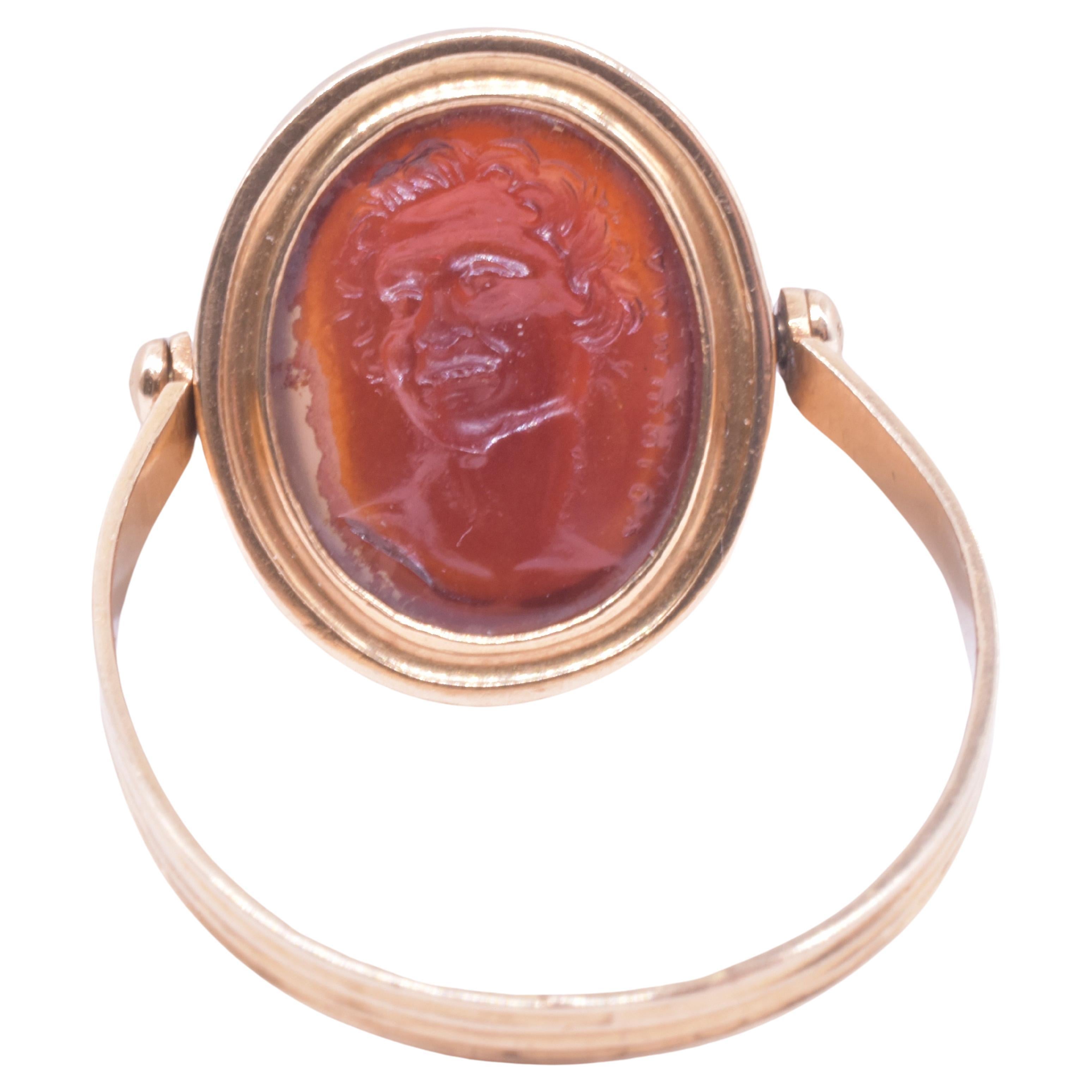 Our C1790 ring is an 18th century glass intaglio  of an ancient signed gem depicting the head of a laughing satyr, or faun (a young satyr). Such carvings were called Tassies (explained further down). 