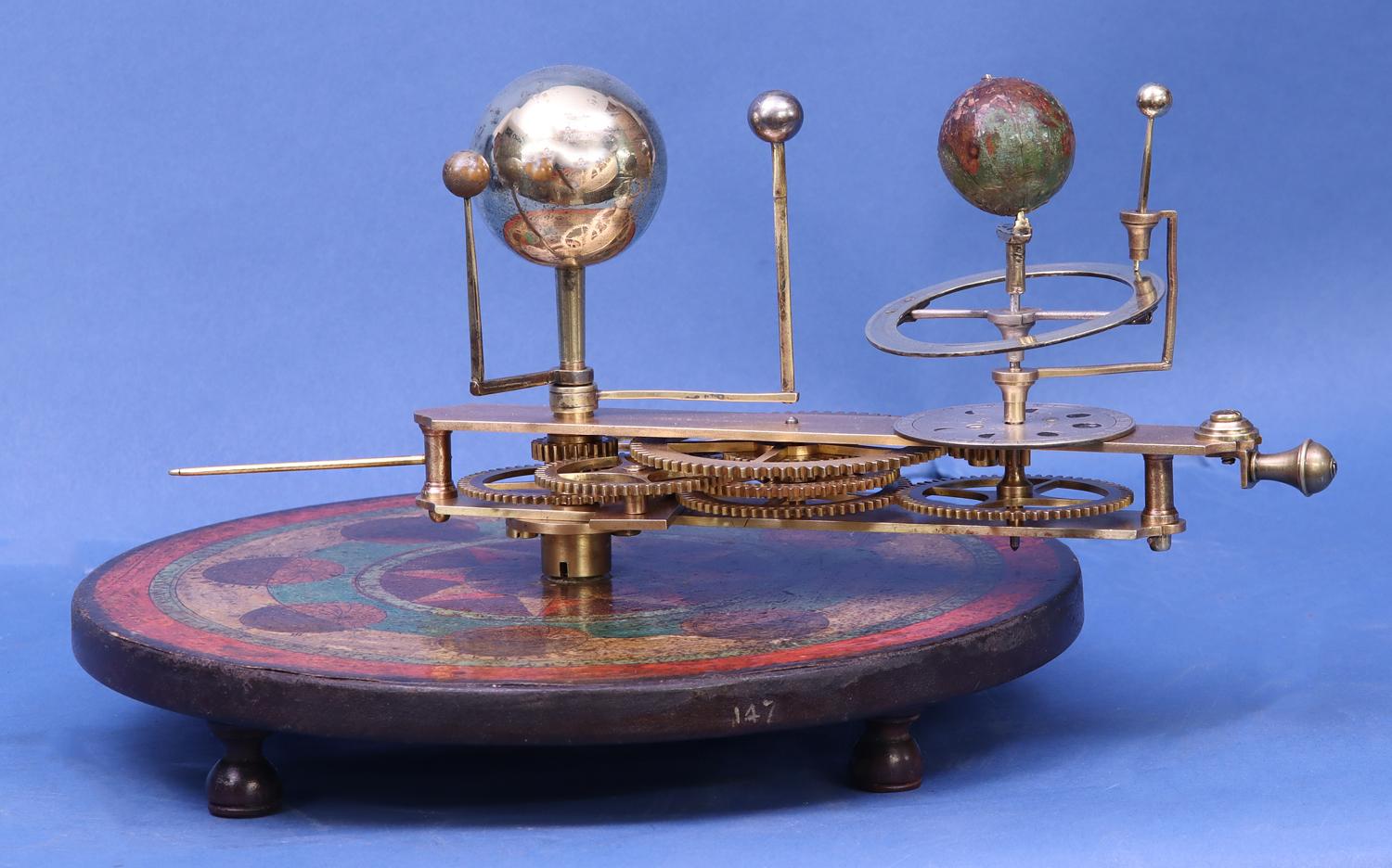 c.1800 Portable English Orrery by W. Robinson

The circular base is covered with a brightly decorated polychrome paper that shows the astrological houses, the months, visual displays of the orientation of the inclination of the earth throughout the