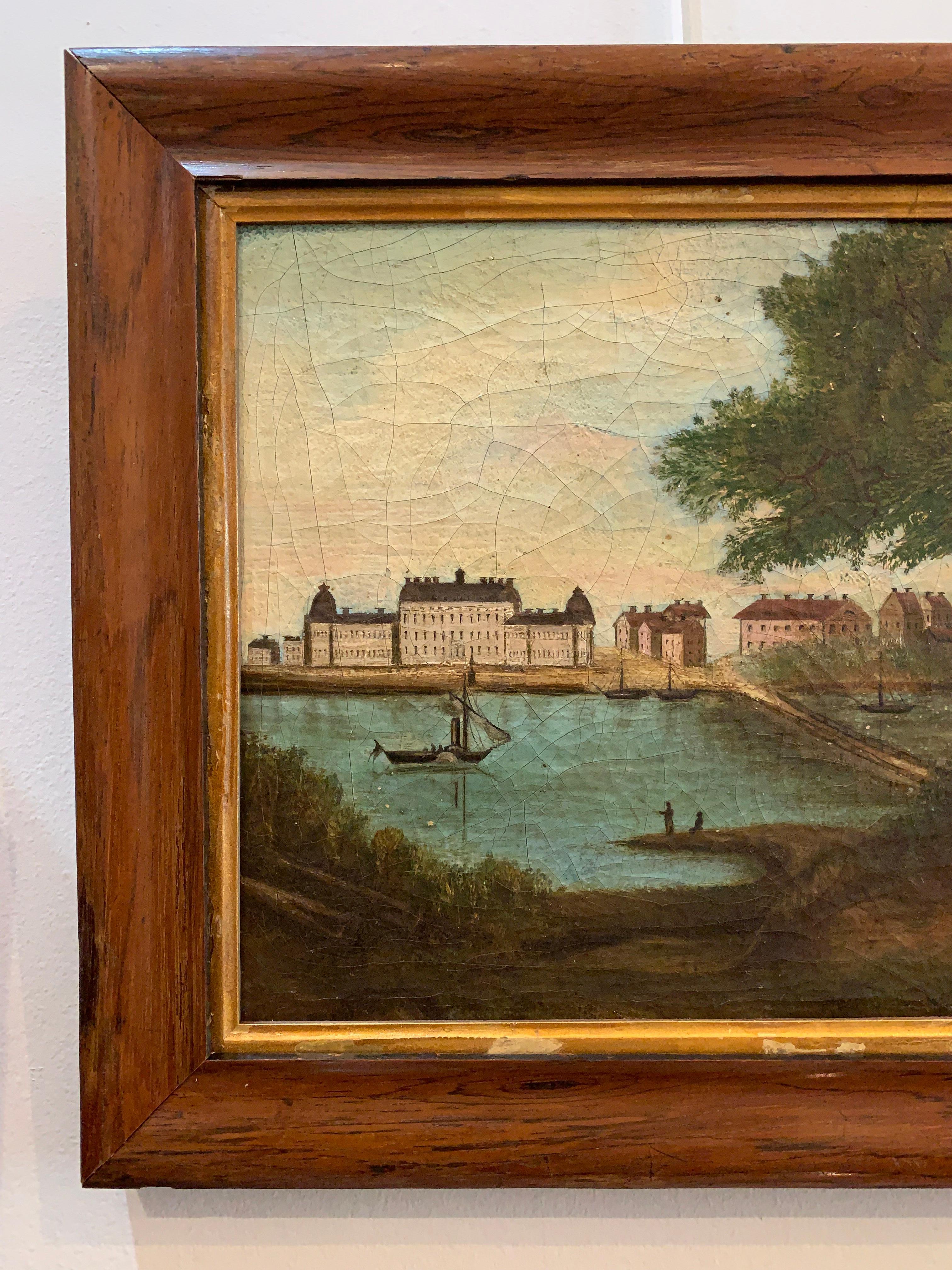 Charming naive/folk early 1800s Swedish framed oil painting of a castle viewed from across a lake where figures are boating and fishing.
The canvas has been laid on board and later framed in a late C19th oak frame.