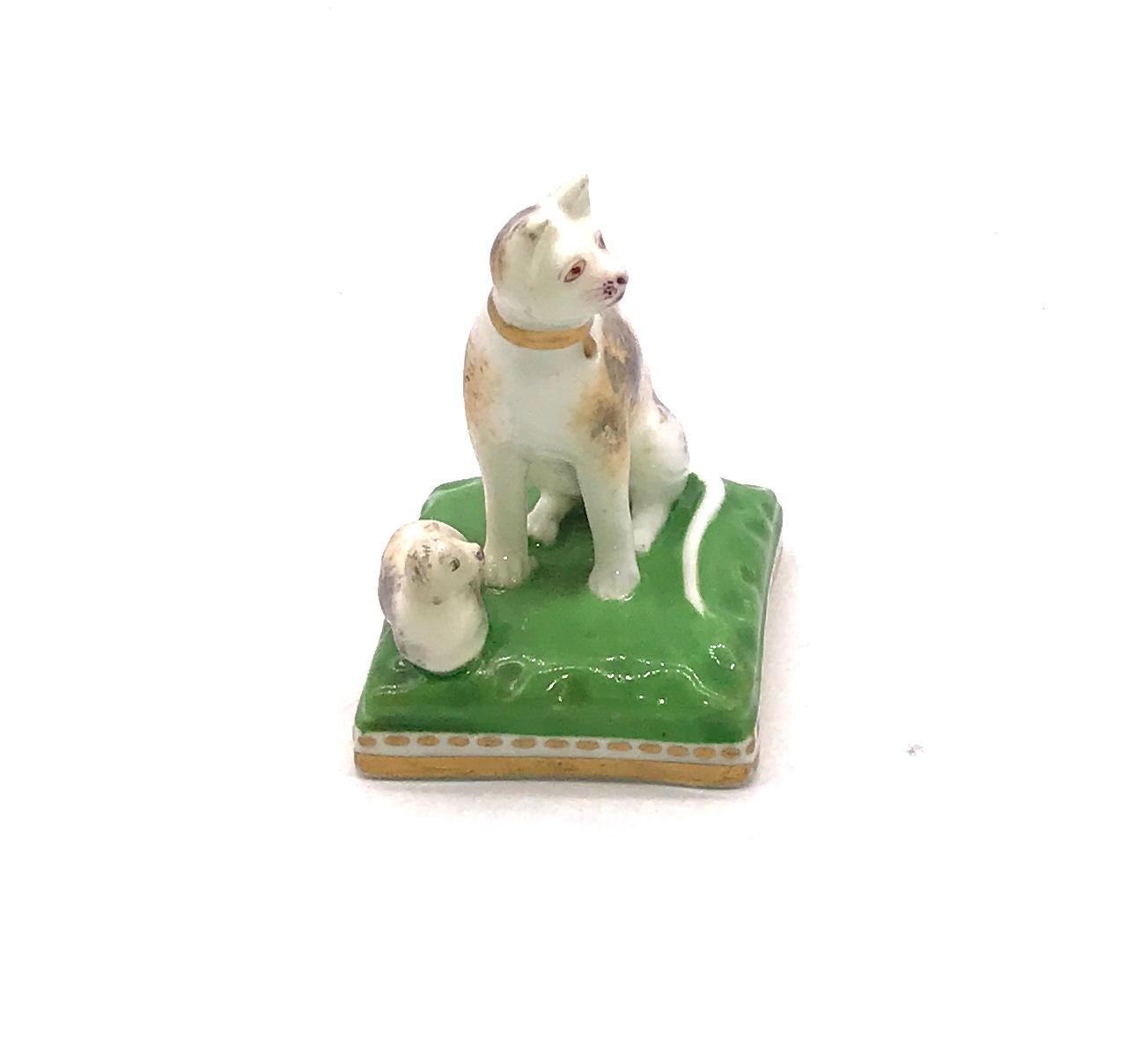 Cats are more rarely seen in porcelain than dogs, this porcelain Chamberlain Worcester cat and her kitten, circa 1810, are seated on a square base., 1.5 inches long and 2 inches high. Robert Chamberlain opened his shop in 1791 and from that point