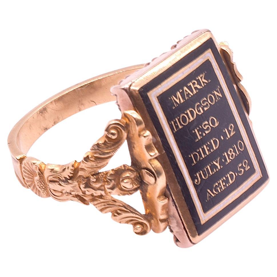 A most interesting mourning ring style of the period; the two sided mourning ring with a swivel bezel.  One side has a lock of hair under crystal and is bordered with pearls, representing tears,  in a pinched gold setting.  The other side is a black