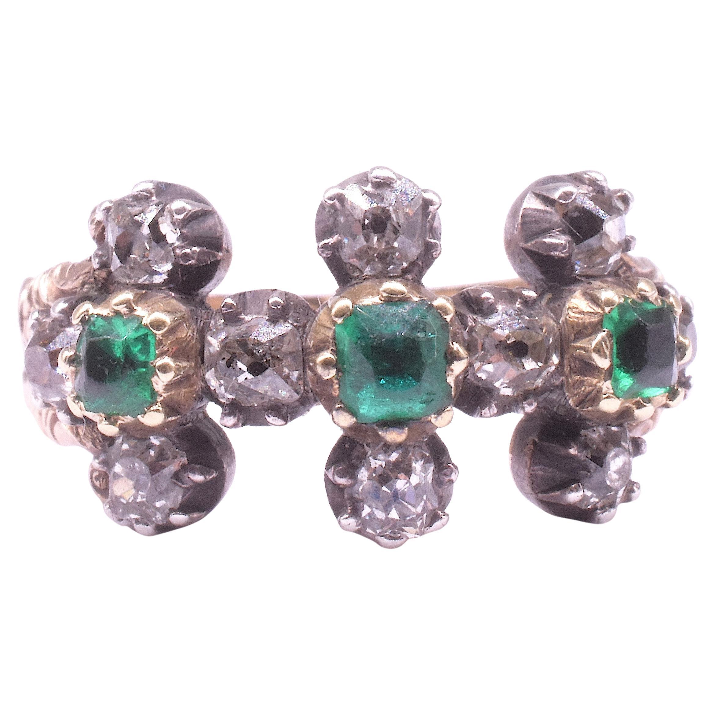 Georgian emerald and diamond ring with gemstones set in a geometric pattern of 3 linked 