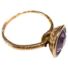 C1820 15K faceted basket set amethyst ring with an ourobouros band