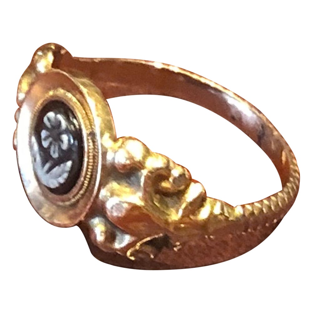 A c1850 18ct gold ring set with an onyx that has a finely carved  intaglio of a pansy.  Victorian's loved symbolism.  The Victorian secret message which is a pun on the word Pansy means “Pense a Moi” Think of me.  This ring may well have been given