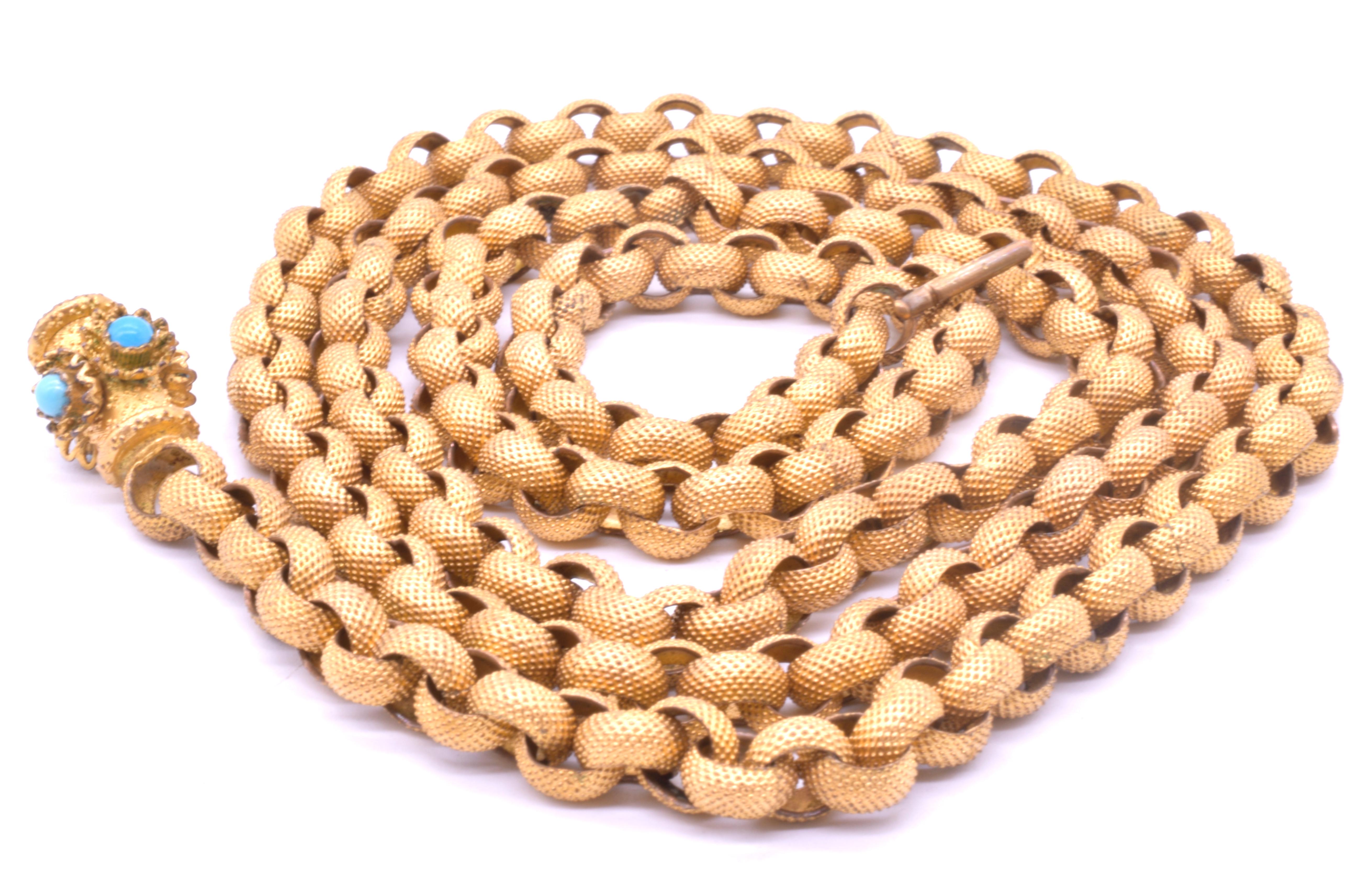Georgian pinchbeck muff chain with a barrel clasp set with turquoise stones in a floral motif. These wonderful long chains were used to hold a ladies muff. The links of the chain, which measures 36