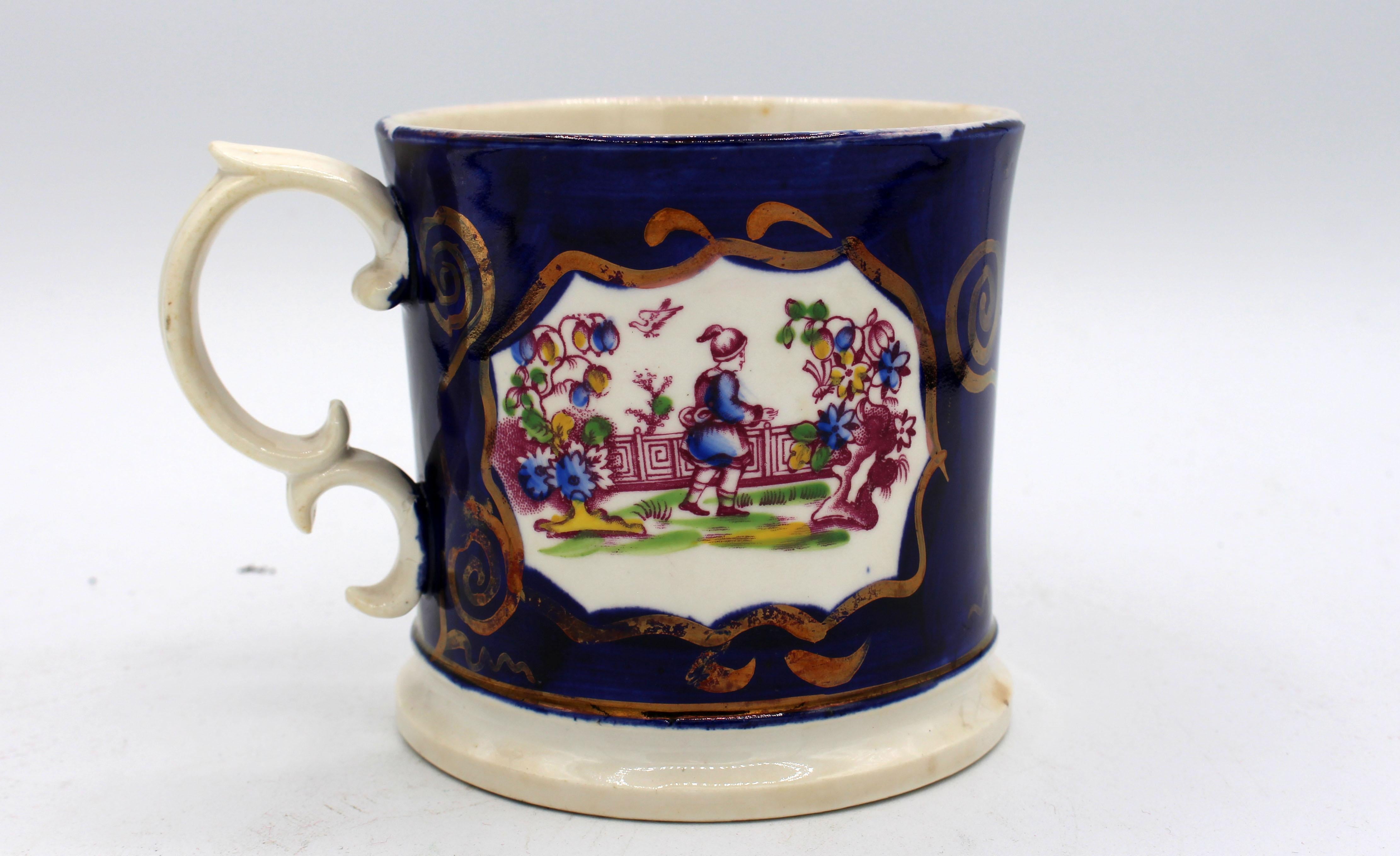Gaudy Welsh porcelain tankard, c.1840-50, with double c-handle. Reserves in Chinoiserie taste with copper luster on cobalt body. Star hairline in base. 5 1/2