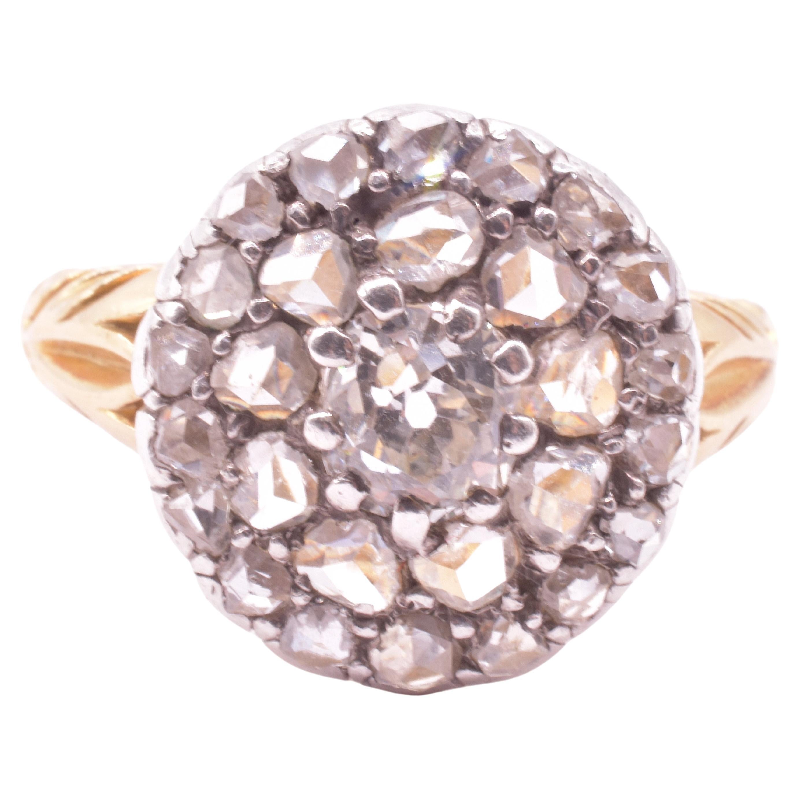 Our 18K gold and silver Diamond Cluster ring is a classic late Georgian cluster ring with with a rare combination of two different types of pave-set Georgian diamonds. This ring has both old cuts and rose cuts, both of which were in use by Georgian
