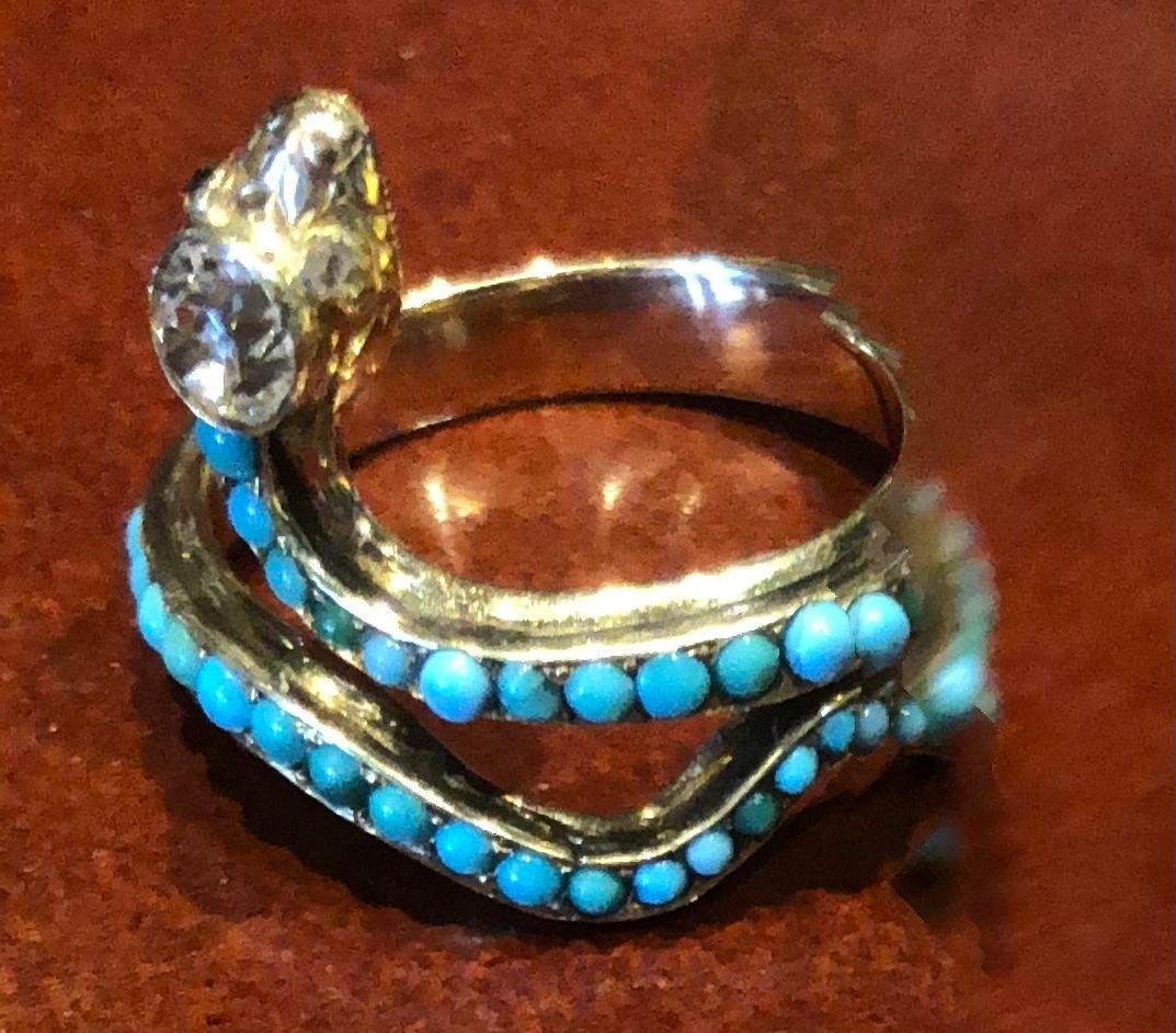 We love this unusual and extremely rare 18ct gold Victorian snake ring  with a cushion cut diamond head and studded with pave turquoise.    It was made during the Darwin years when nature was a often source for fashion.  Since ancient times snakes