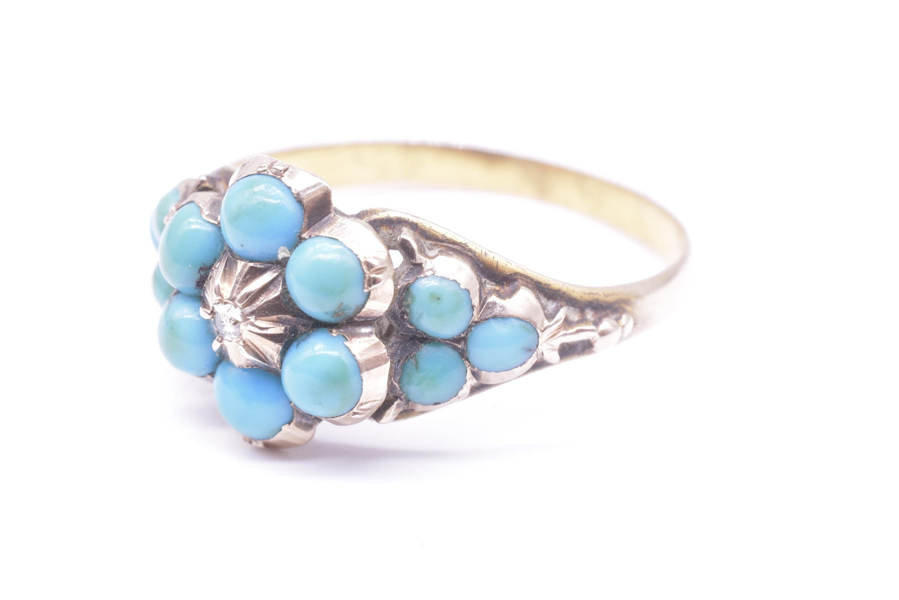 Victorian Forget Me Not ring 15K set with six turquoise stones surrounding a single diamond at the center and 3 supporting turquoises on each side. The flower literally means “forget me not” and the small rose diamond in the centre signifies eternal