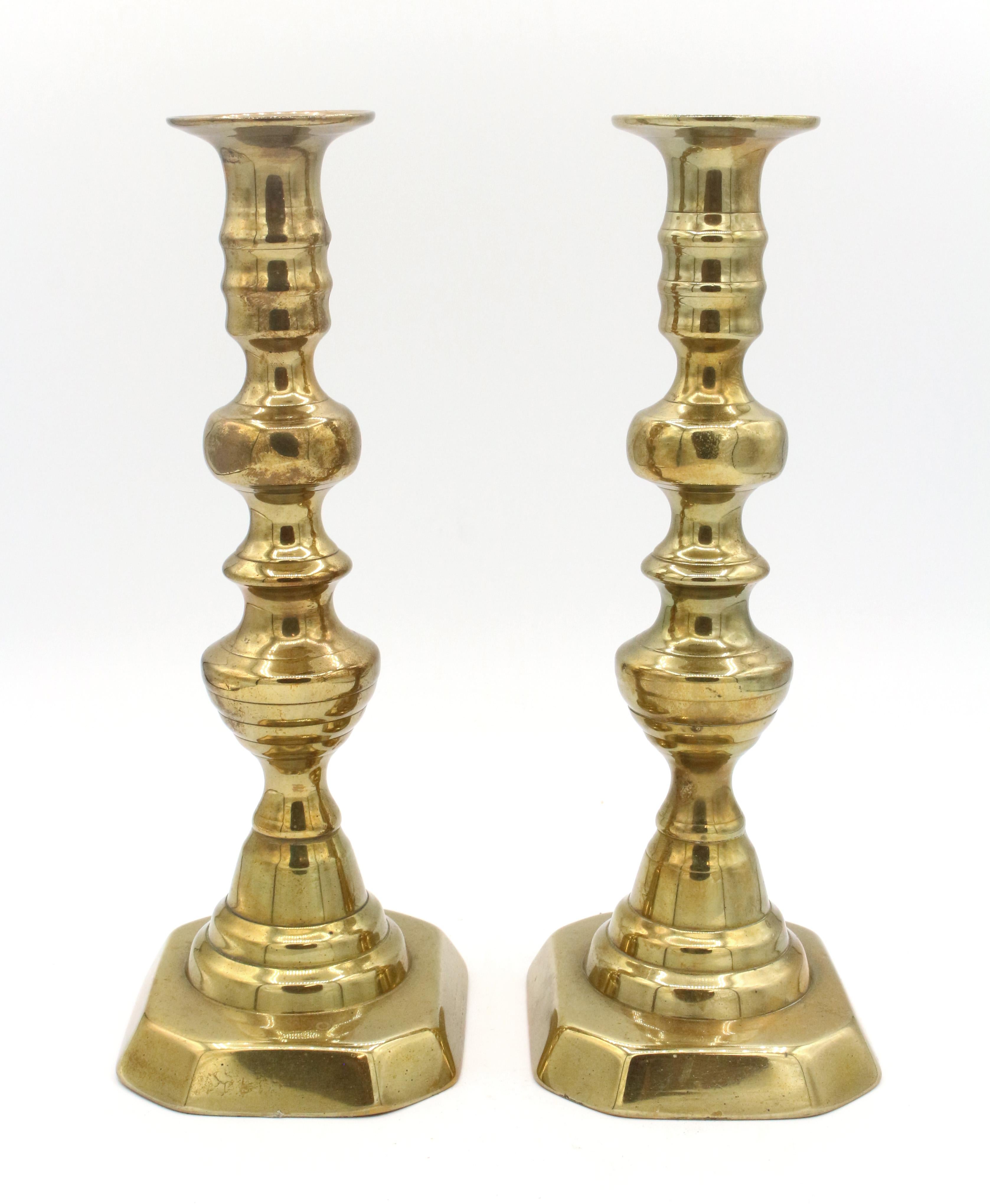 Pair of brass candlesticks, English, beehive design with push-rods (one lacks button), circa 1860s. Measures: 9 1/2
