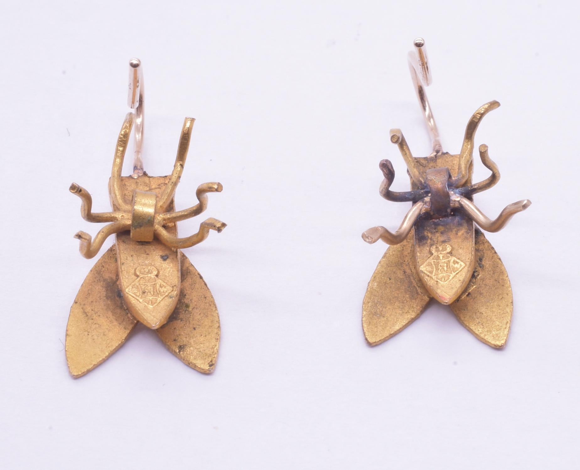 We love these 20 mm long fun fly earrings made of various metals. They are quite realistic with their textured bodies, membranous wings and bulbous eyes. The fly earrings perch on realistic looking wire legs and attach to 9K (marked) shepherd's