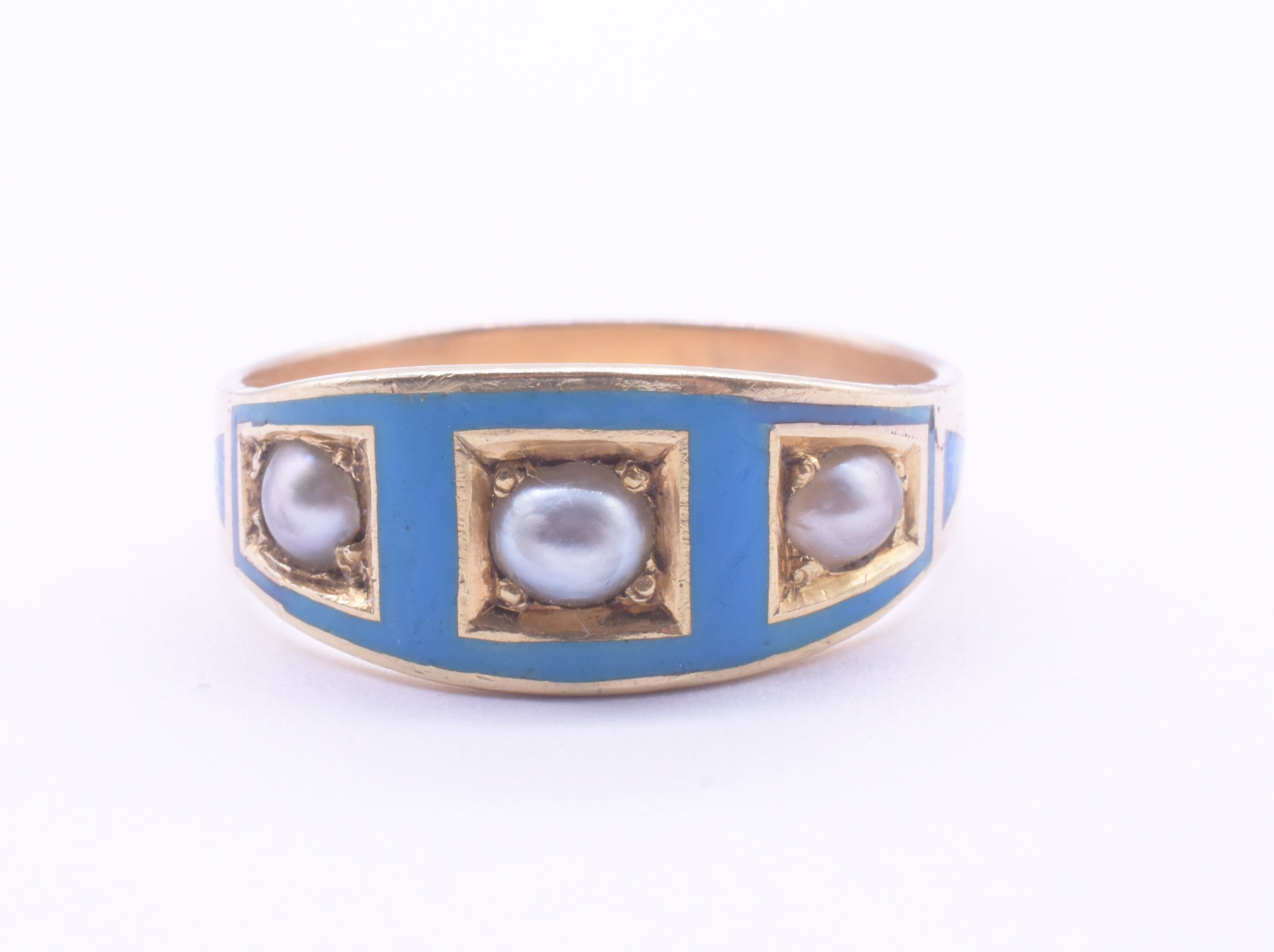 This is a unique 3 stone ring with its pretty hand painted Cambridge blue enamel detail and 3 well matched pearls symmetrically placed with the 2 slightly smaller pearls flanking the center pearl. A variation of what used to be called the gypsy