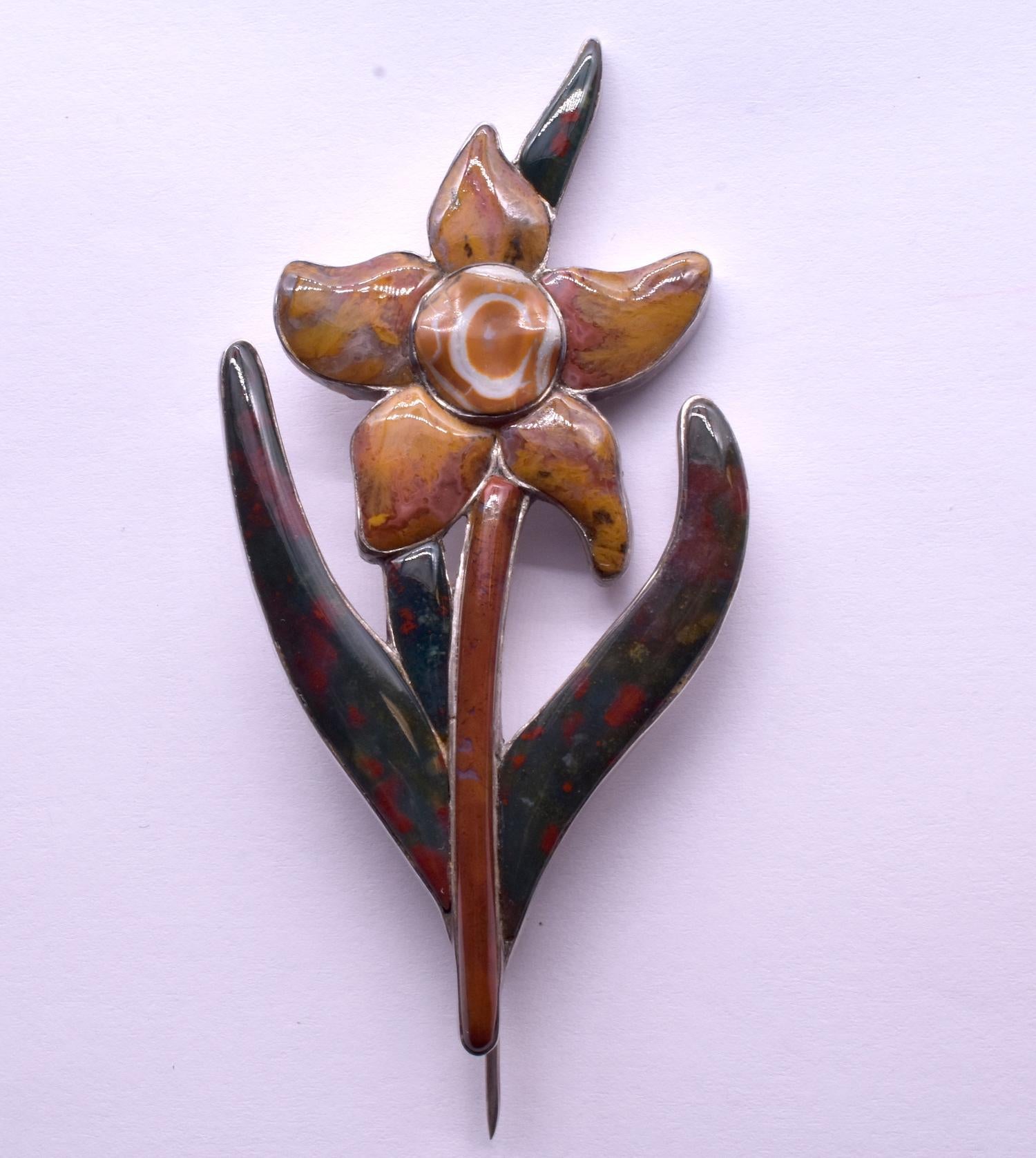 With its warm colors and natural striations, our Victorian silver daffodil brooch, c1870,  is handcrafted with a high degree of skill and the agates are carved perfectly to fit their sterling silver mounts. The smoothness of the agate, the