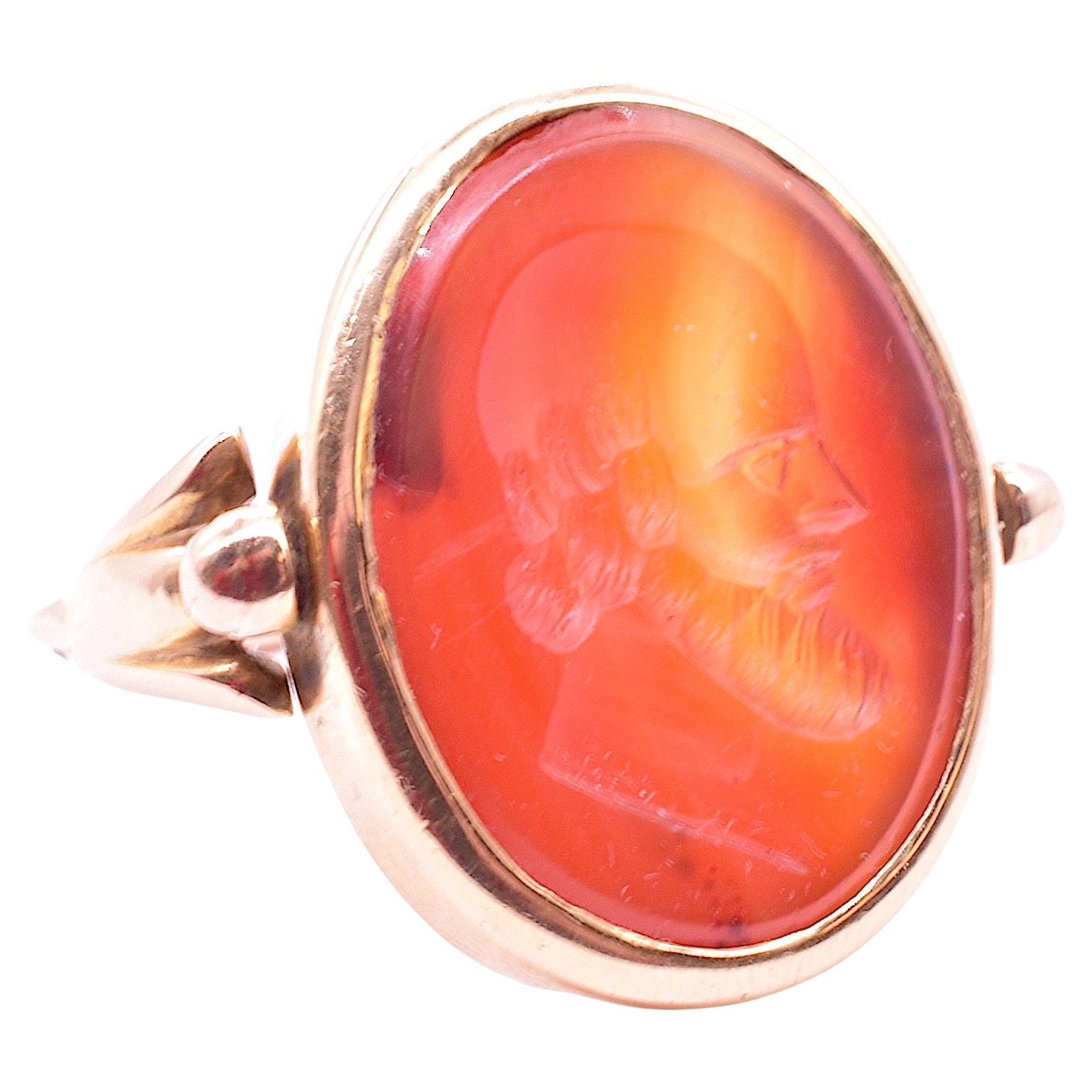 Victorian 15K Carnelian agate swivel ring of a classical male head in profile. The translucent yellow orange glow of the Carnelian stone mesmerizes and the swivel motion of the band satisfying. On the main side there is a carving of a bearded man