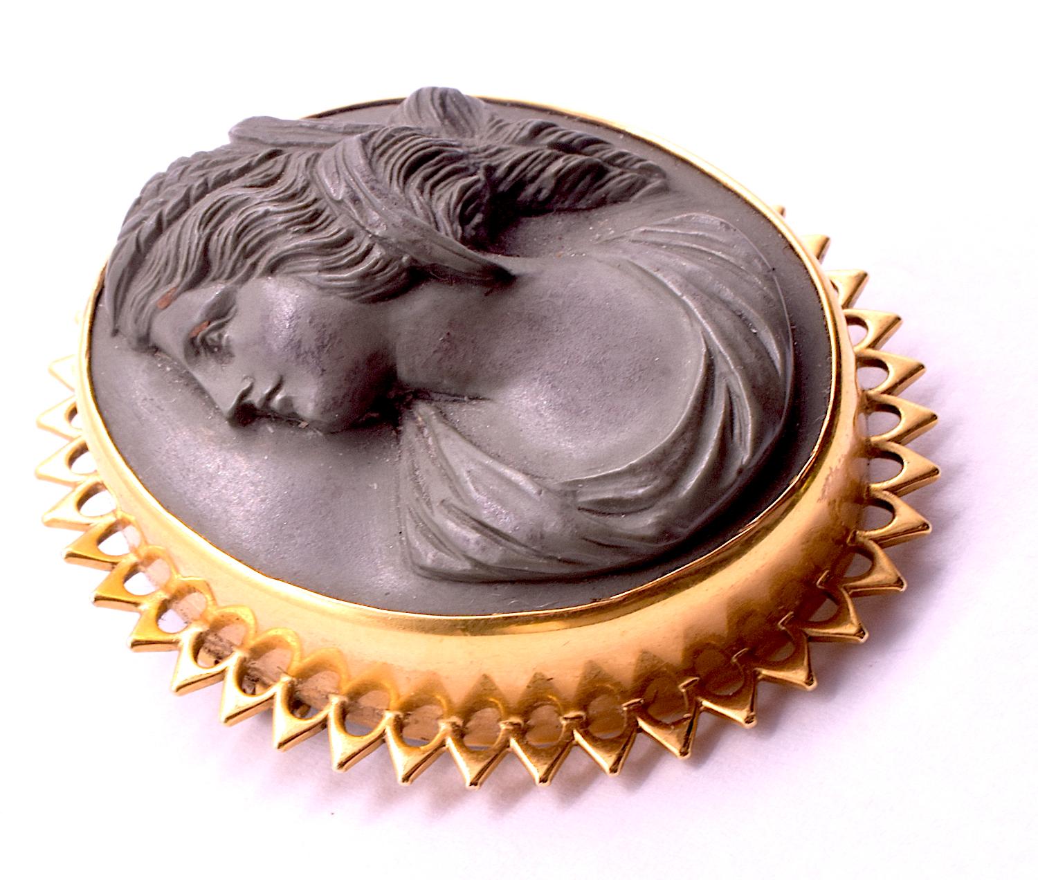 Lava cameo brooch of Demeter, or Ceres in Latin (as she was known to the Romans) with a crown of wheat sheaves in her hair. The gold openwork bezel is of 12K and is an unusual pointed shape. The carving of the folds of her collar as well as the