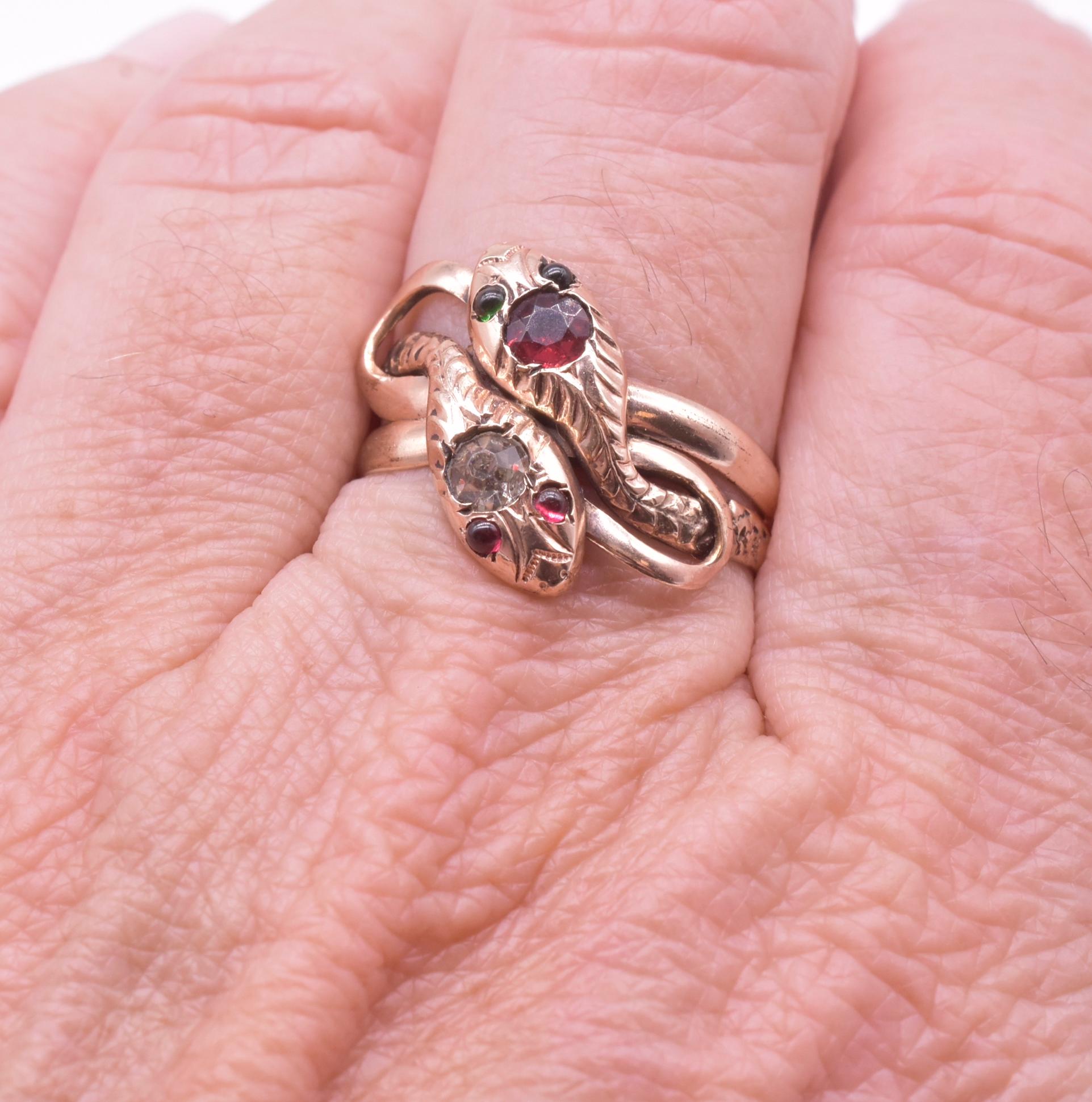 Substantial Victorian 10K double headed snake ring with diamond and ruby paste heads and  two pairs of glowing paste eyes, one set of 