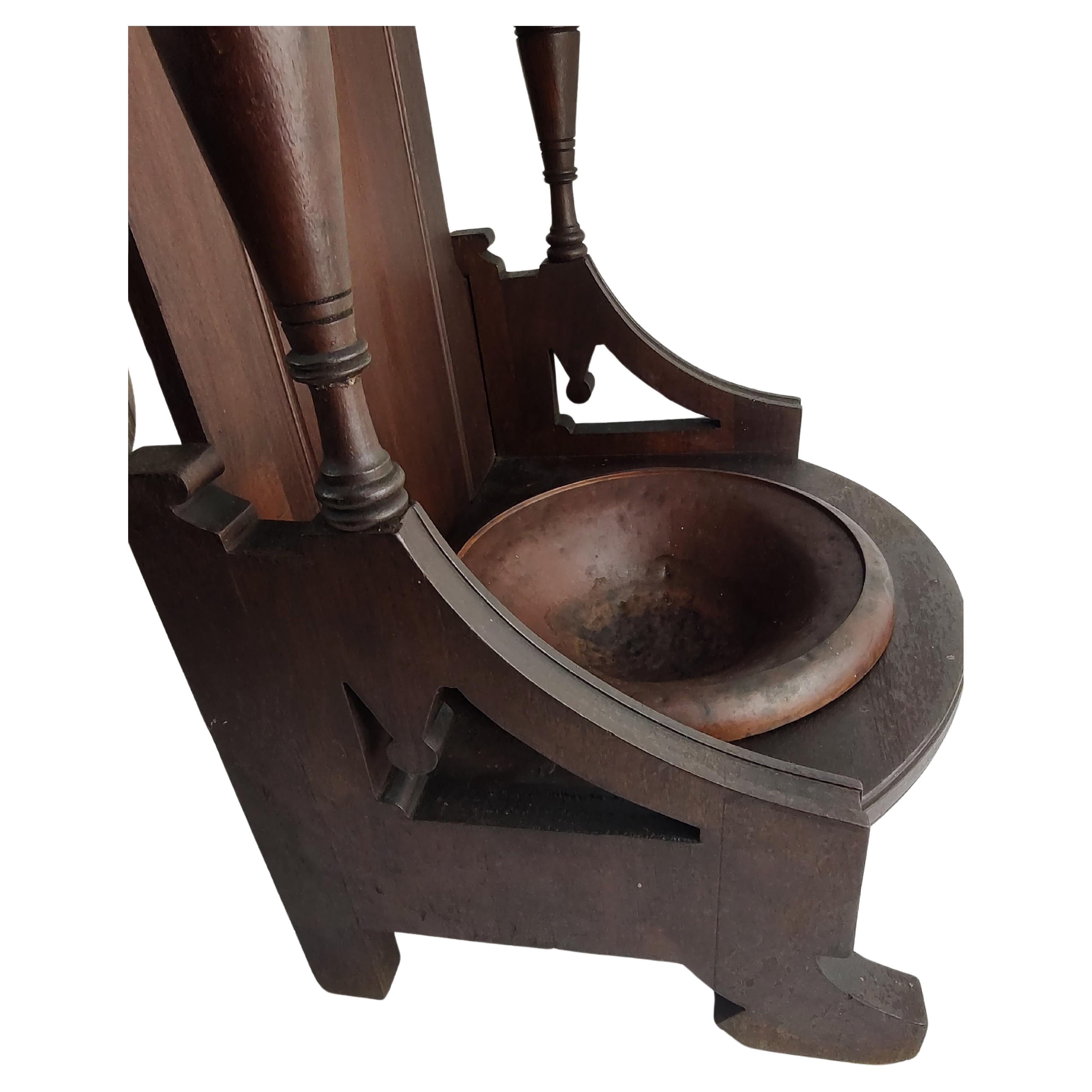 Fabulous and a unique form umbrella and cane holder in mahogany with it's original copper pan. Pan lifts out. Carved flowers on upper portion with turned posts. In very good original finish and condition is great.  