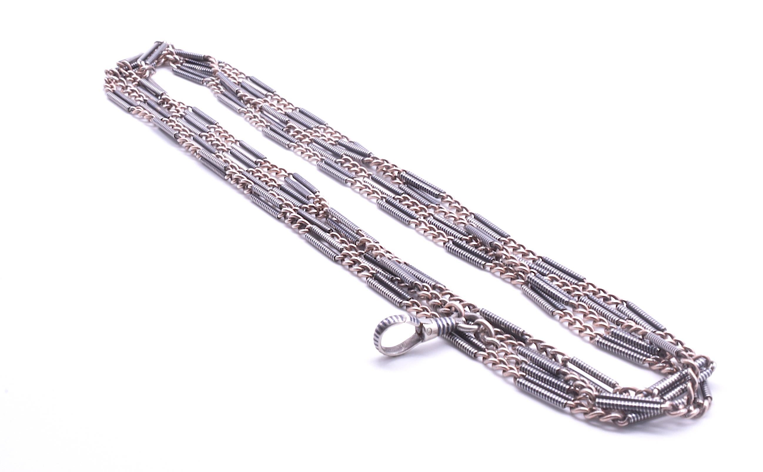 The rare original Niello watch chain that you have been searching for. Fifty Six inches long, our chain has niello patterned fetter links and alternating triple gold links. The fetter link has a wonderful striped pattern wrapped around a gold link,