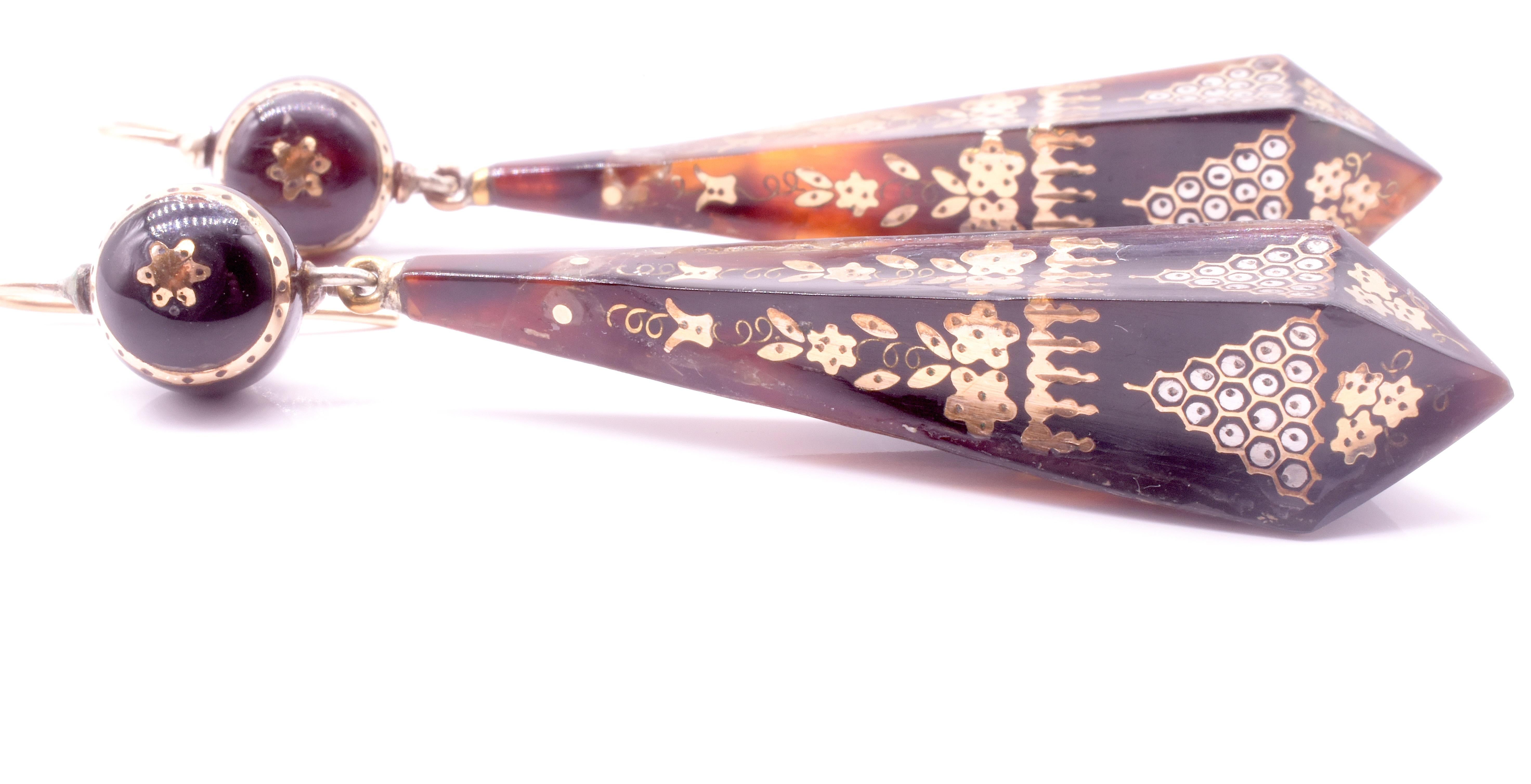 Charming prism Victorian pique earrings with round tops long prism shaped bottoms and inlaid on 2 sides with gold flowers and beehive decoration. 

Pique jewelry was a uniquely Victorian craft, and its origin lies with the French Huguenots in the