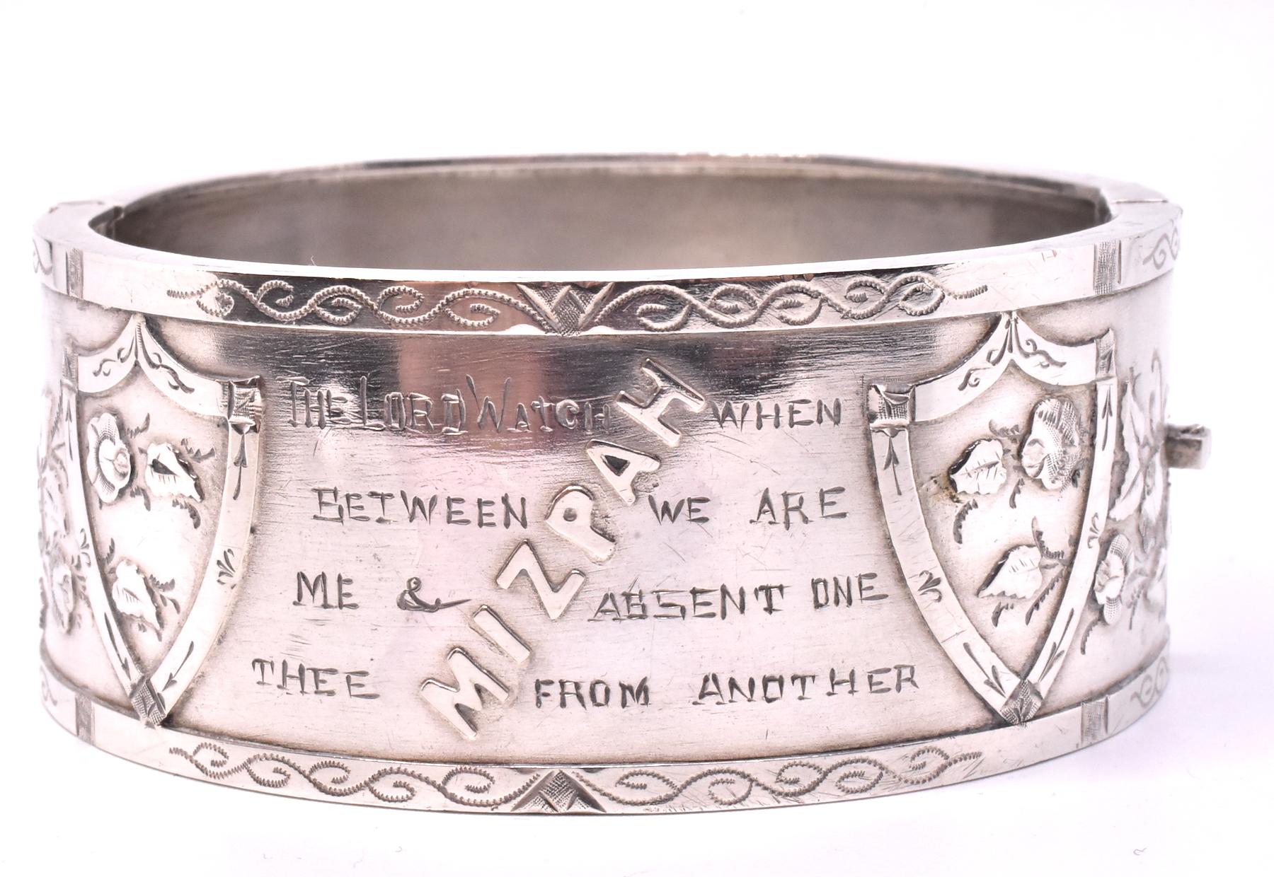 Sentimental sterling bangle bracelet bearing the biblical Mizpah inscription, signifying an emotional bond between two people physically separated due to acts of war or other calamities. It would typically be given by a lover about to be parted from