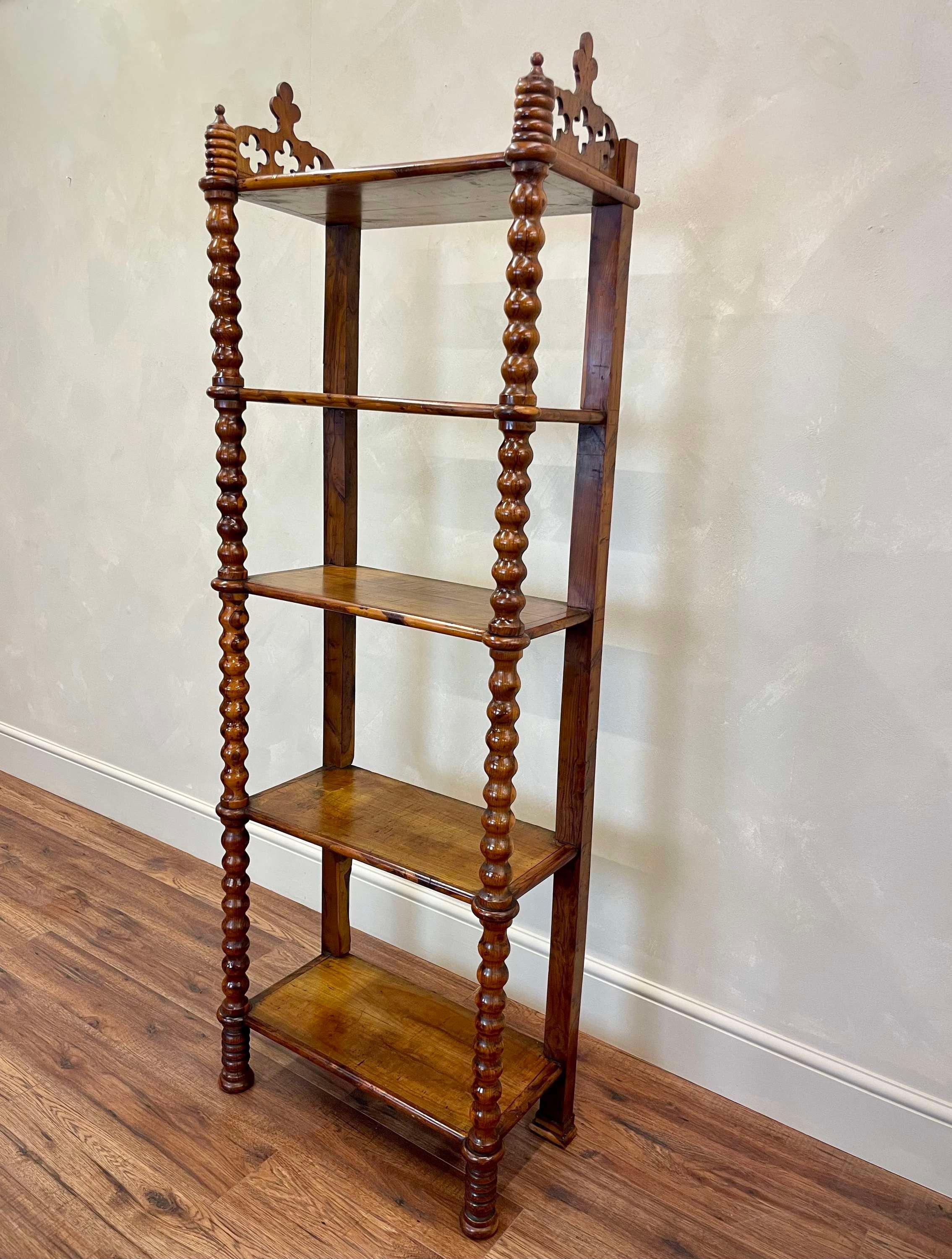Antique French Shelving Unit in Cherry Wood.
This free-standing etagere / shelving unit has 5, solid cherry wood shelves, with beautifully carved bobbin pillars to each front corner and flat pillars to the back.
To each side of the top shelf, sits