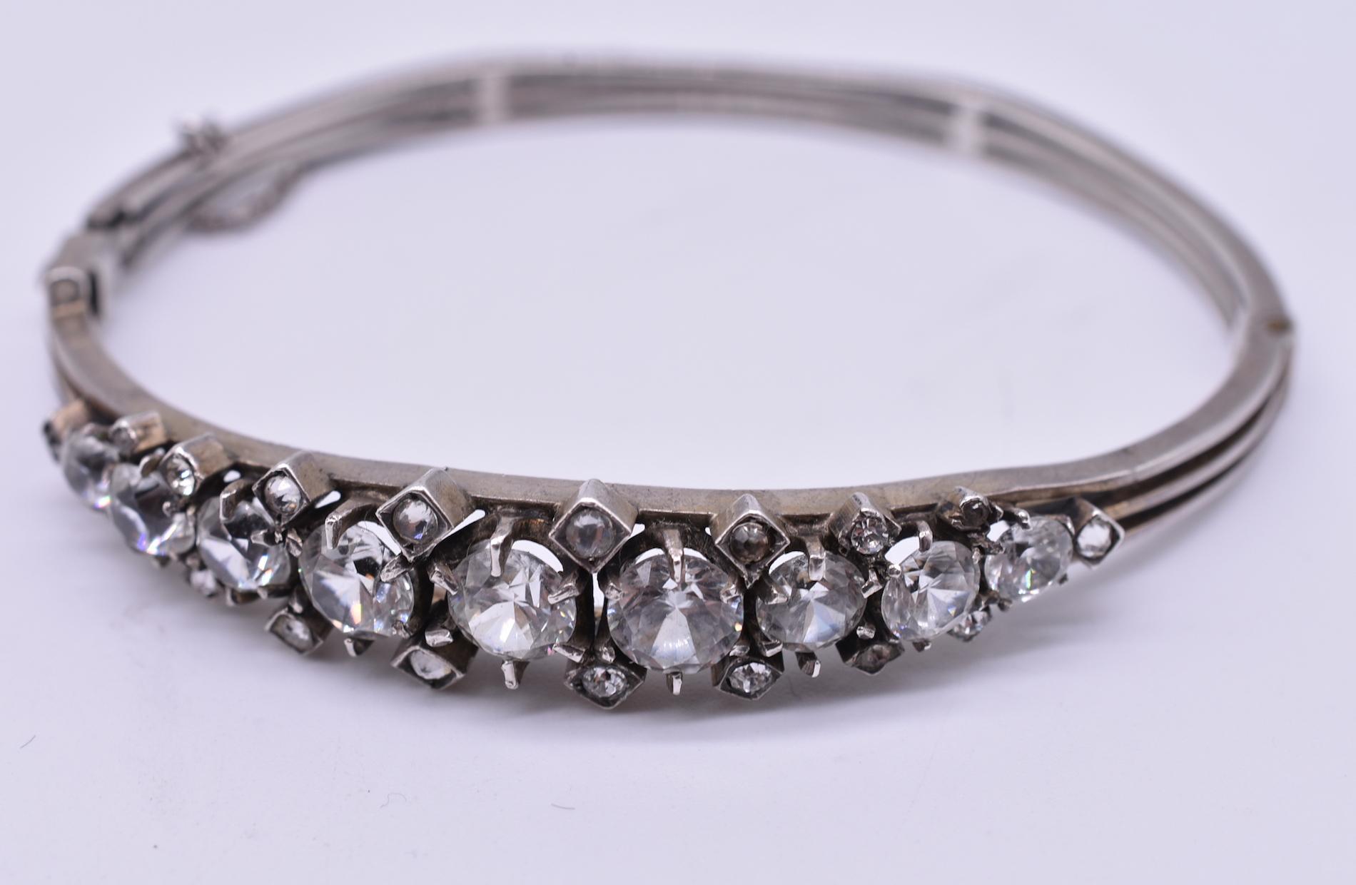 Fun silver bangle made from paste, which easily transitions from casual wear to a night on the town. Paste stones are made from leaded glass, the formula for which was perfected in the 18th century by a jeweler name Georges-Frederic Stras and soon