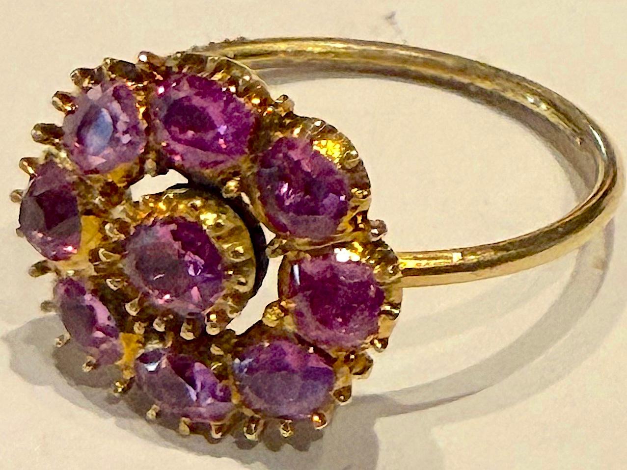 A gorgeous,  flower form ring decorated with  2 carats of cushion cut natural pink Sri Lankan sapphires set in an 18K yellow gold band, circa 1900, size 7.25.


