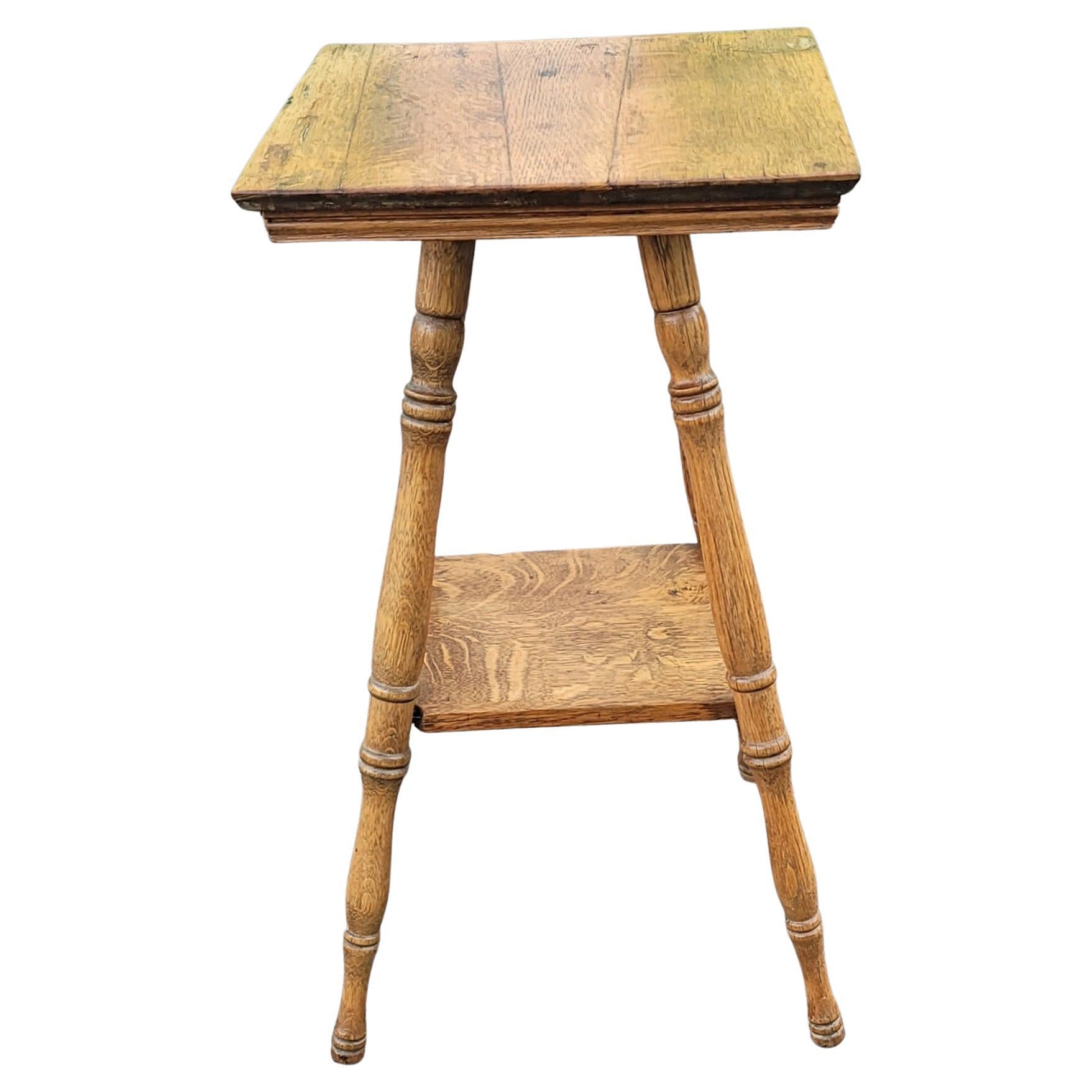 An early 1900s American Classical Oak Parlor Table with Turned Legs. 
Measures 16 inches square and stand 29 inches tall.
