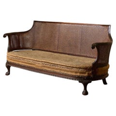 c.1900 Bergere sofa with shapely arms