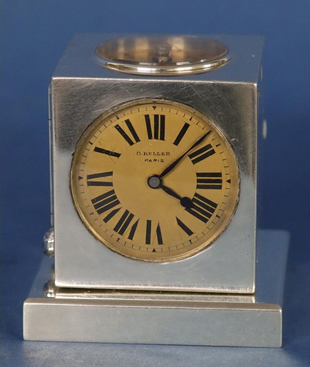The silver cube features a clock, compass, engraved Fahrenheit and Celsius temperature scales, a monthly calendar and a barometer and is mounted on a silver swivel base. It is punched several places with a silver mark containing the initials