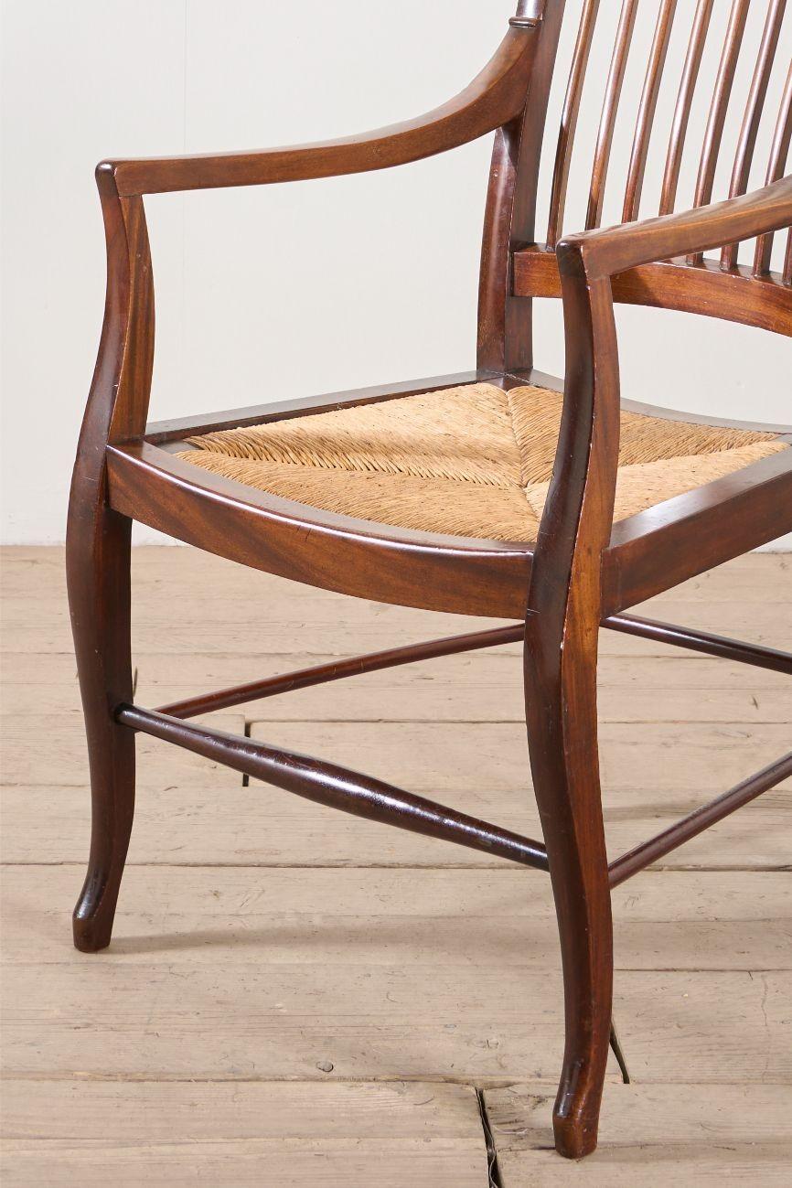 This is a very nice quality c.1900 mahogany and rush library chair. Beautiful condition with an attractive aged patina and perfectly useable. Generous size as well. It would make a great occasional table or desk chair. The whole design is very