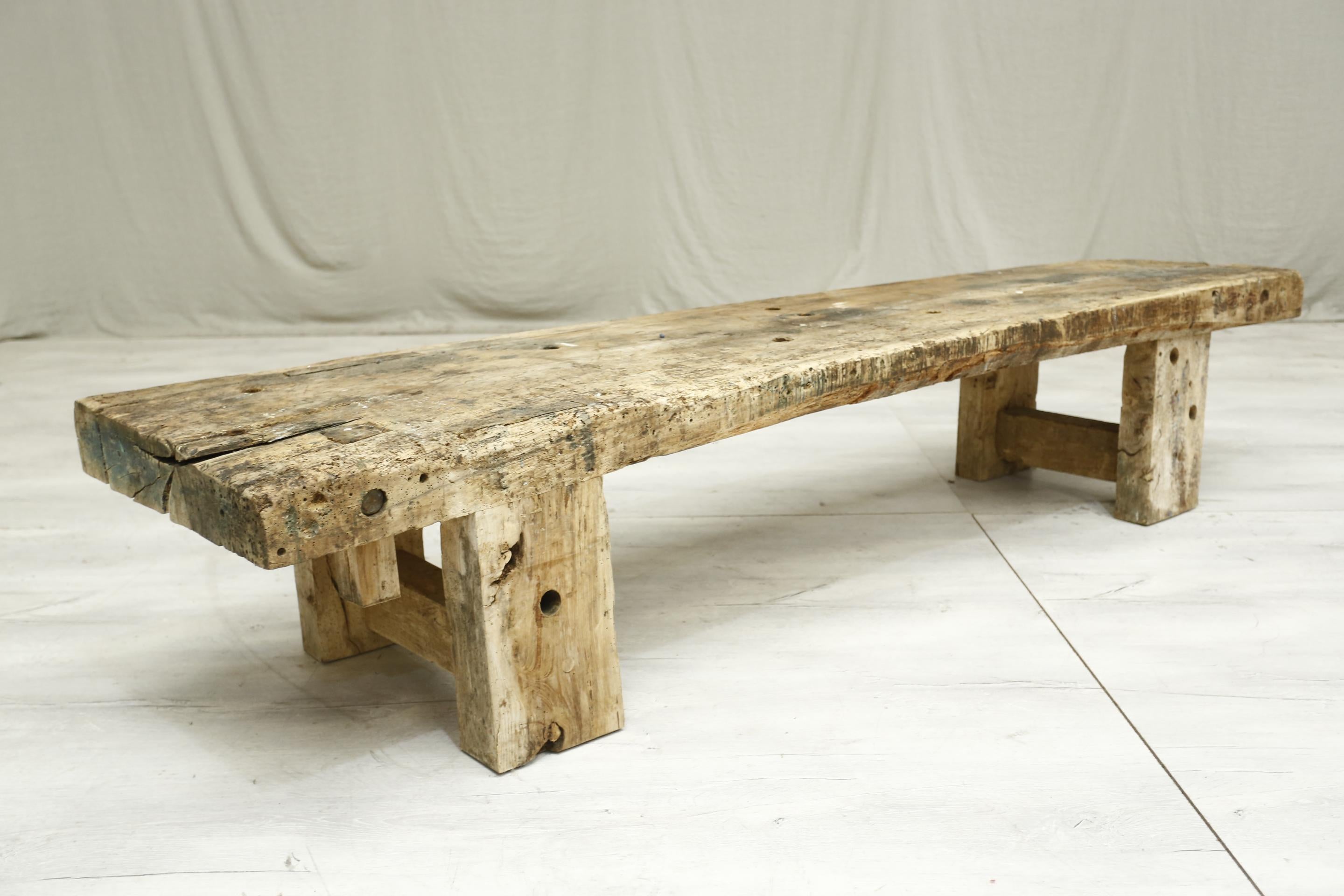 This is a stunning very large, rustic elm pig bench. The patina is incredible and really will stand out as a coffee table or bench in any interior. It looks to have been used as an industrial bench in its life but this only adds to the character of