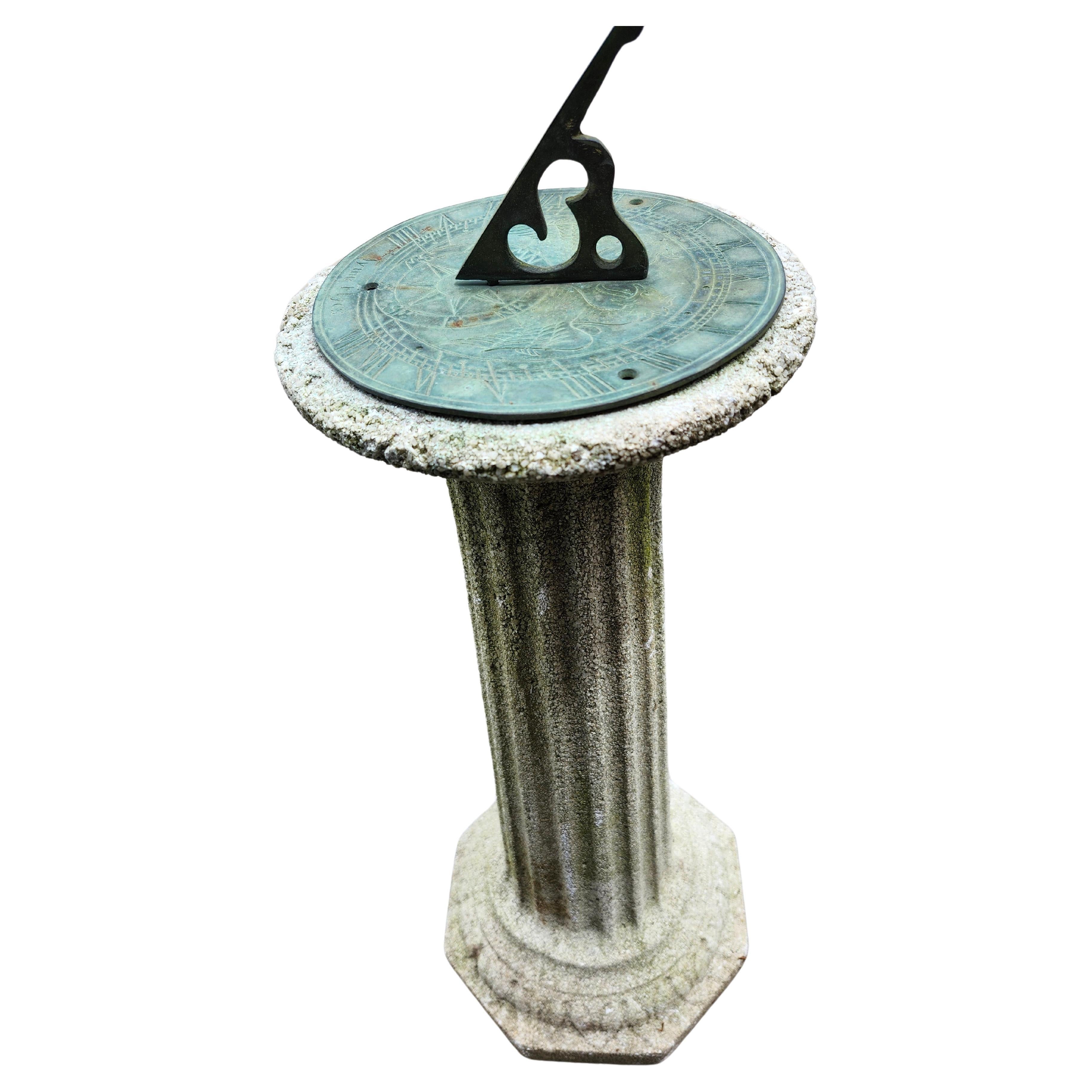 Superb example of a classic cast stone pedestal with a bronze sundial on top.
Fantastic verdigras color and patina to the sundial,  the pedestal has a minor chip on the top rim, pictured. 
Otherwise in exceptional antique condition with great wear