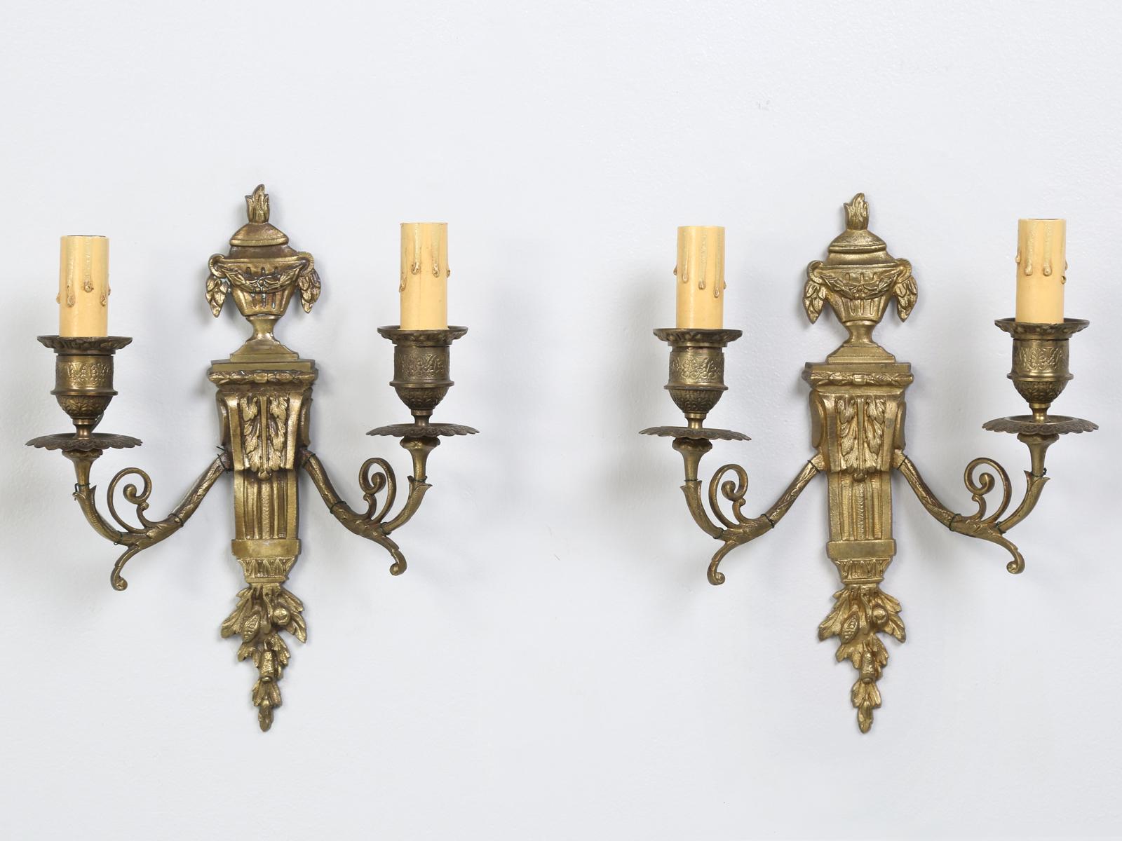 Outstanding pair of vintage bronze, French Empire, highly stylized 2-light sconces. Gracious, petite, and unmistakeably French, this is a truly unparalleled pair of unique sconces. Rewired.<br />
<br />
* The first height does not include the