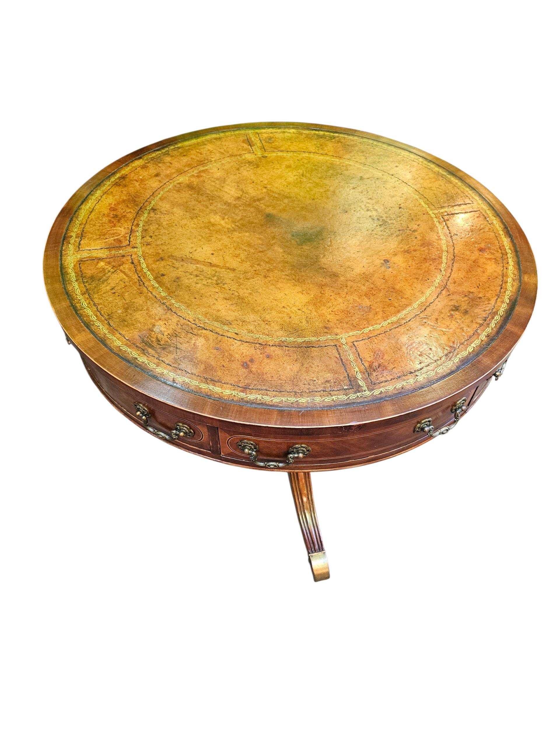 Fine Quality Regency Style Drum Table
 Insert tooled Leather Top
Four ebony Drawers
Raised on turned Column on Outswept Legs