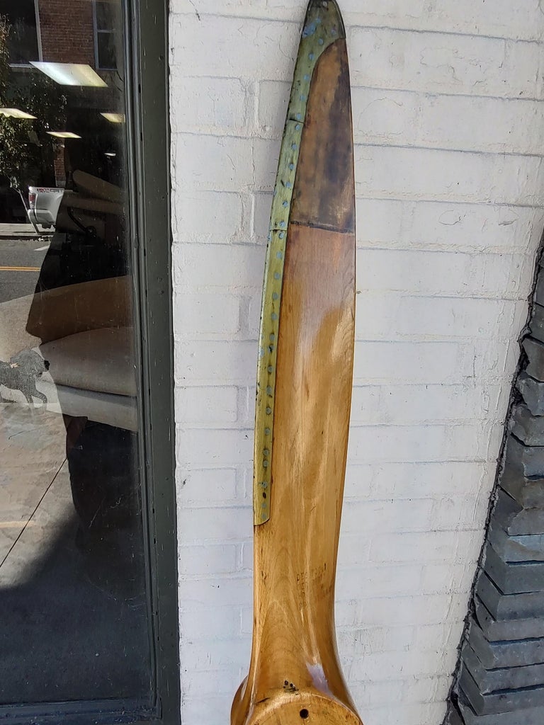 Fabulous and in excellent vintage condition with minimal wear. C1940s wood airplane propeller with brass trim on edges. Marking on the wood give some insight to the specifics.