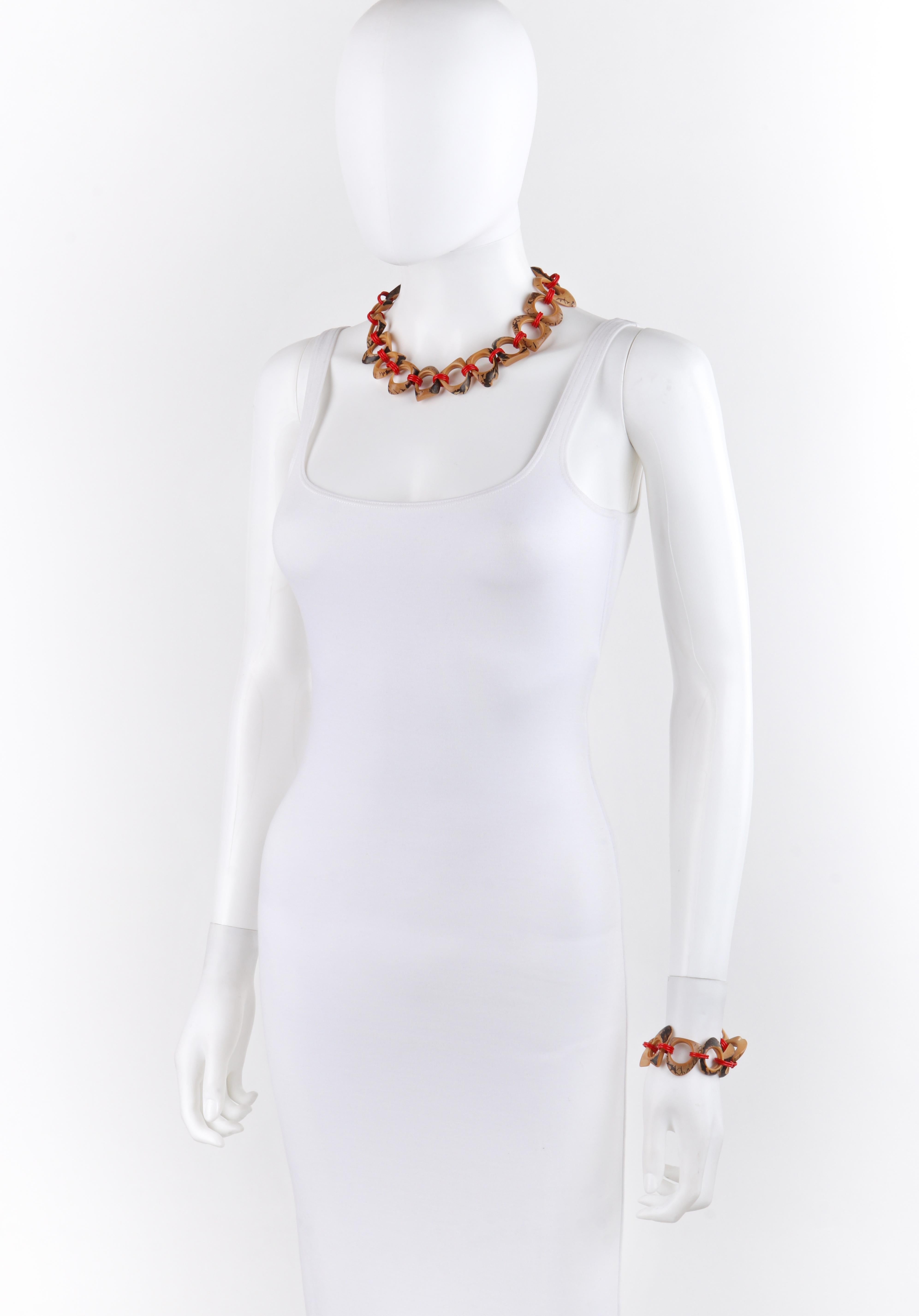 c.1940s-1950s Brown Red Plastic Abstract Sculpted (Carved Wood Look) Chain Necklace Bracelet Set
 
Circa: 1940s-1950s: 
Style: Chain bracelet and necklace set
Color(s): Chain: shades of brown; links: red
Unmarked Material (feel of):