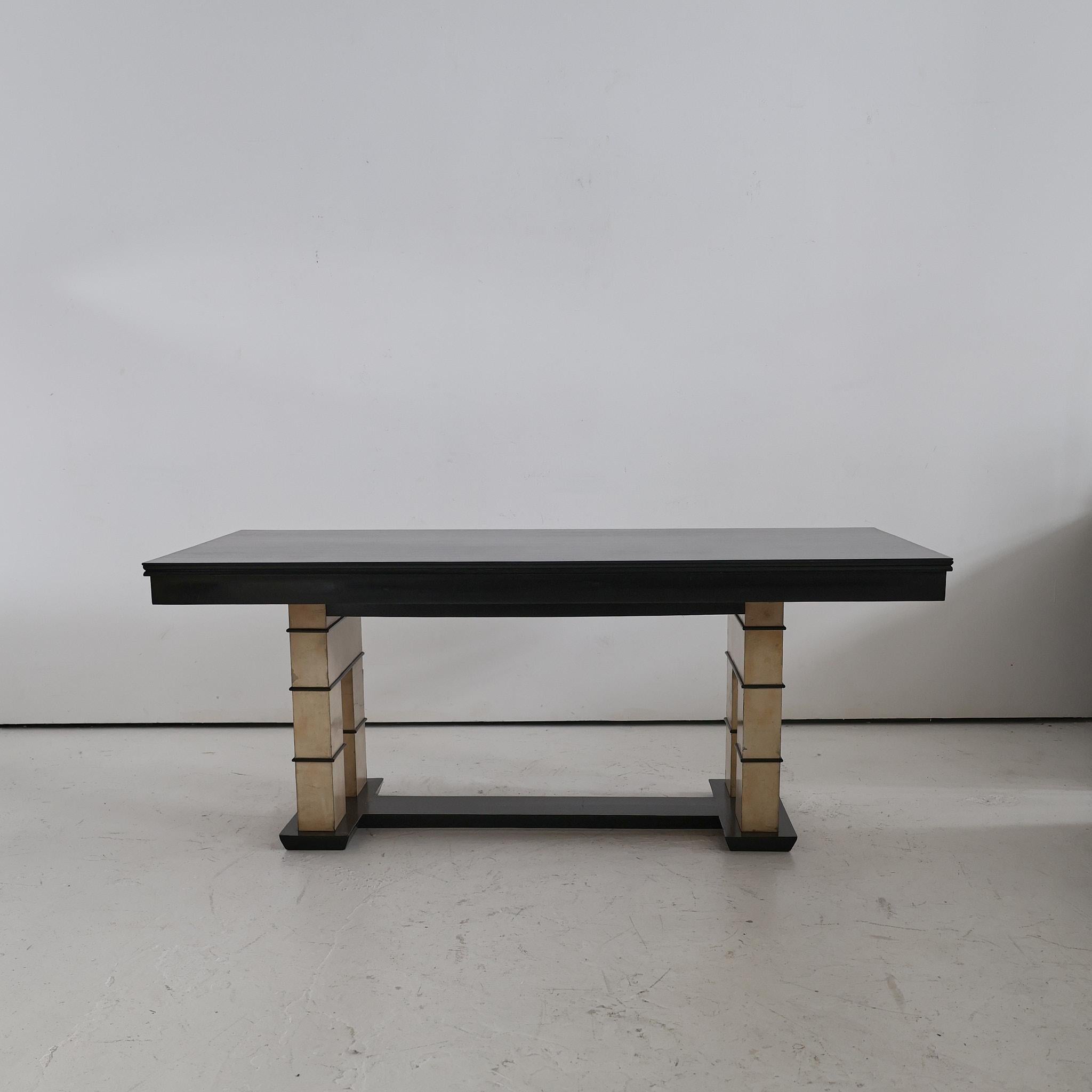 A rare 1940s northern Italian vellum and ebonised mahogany table.

A strong angular modernist design with beautifully patinated velum/parchment legs and recently re-polished ebonised mahogany top.