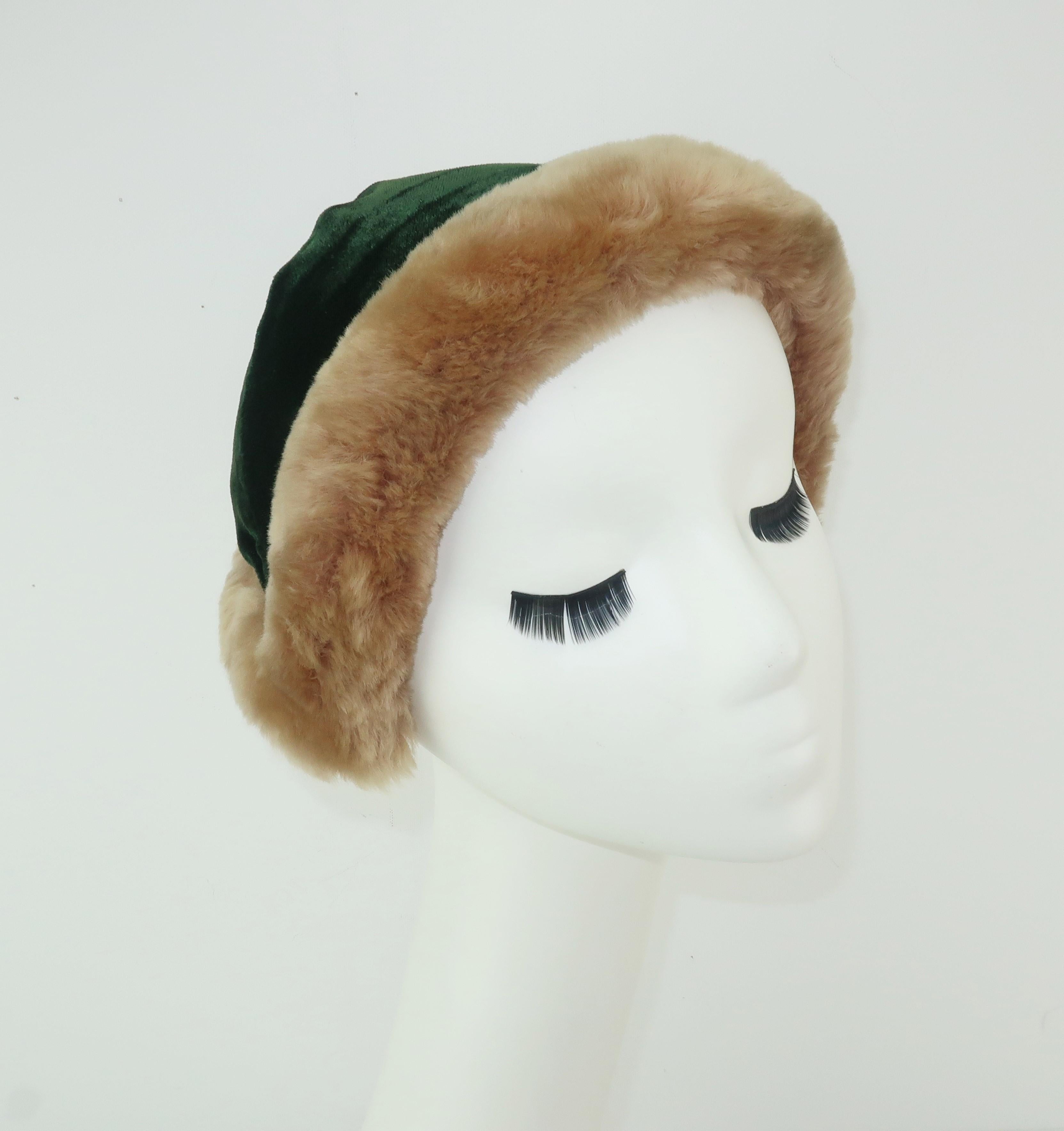 This adorable C.1950 hat conjures up images of princess coats, muffs and ice skating in the park.  The lush dark green velvet body is backed by black faille fabric and trimmed in a fawn color mouton sheepskin.  The hat is cleverly shaped by a hidden