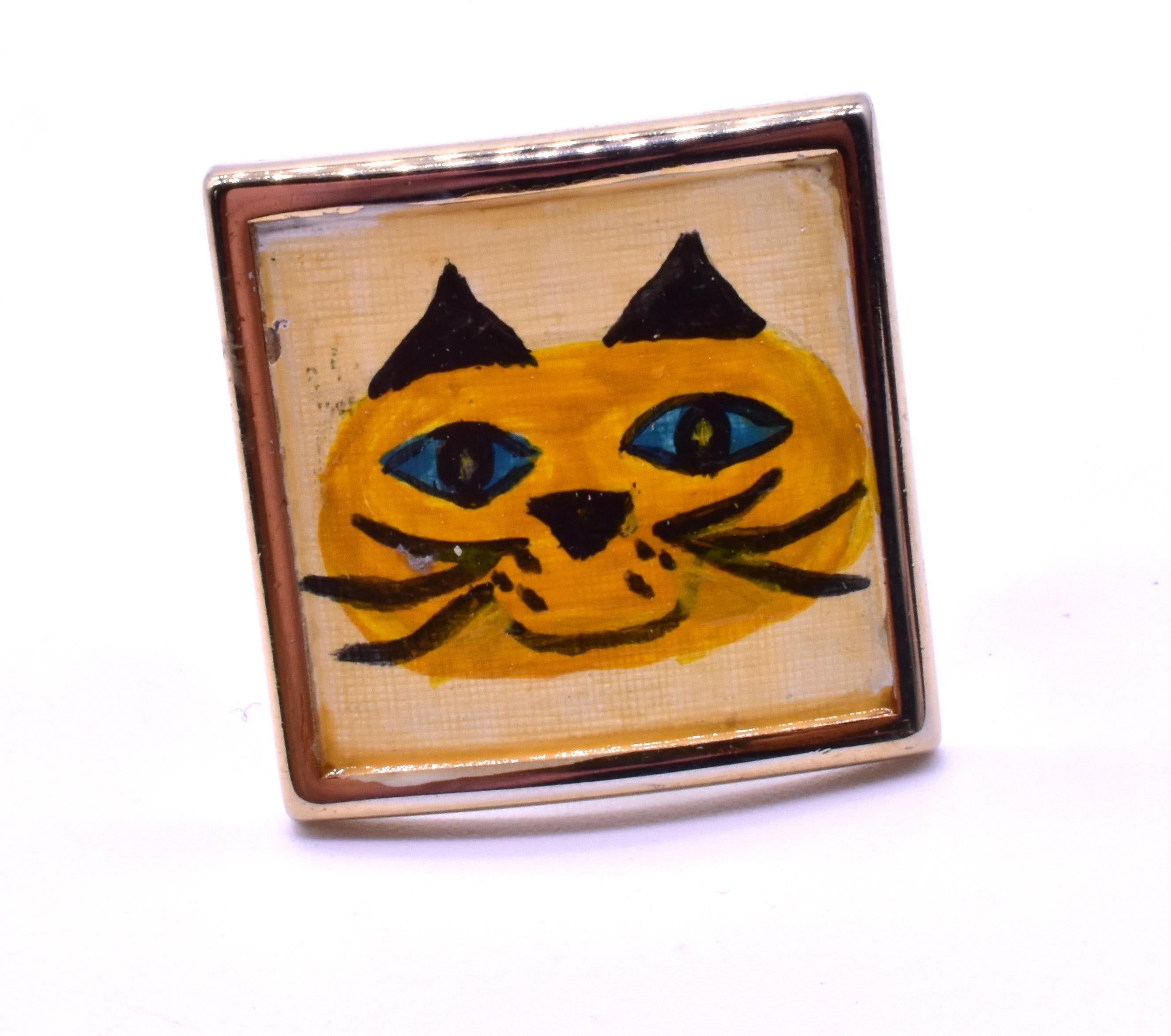 Circa 1960, these gold filled painted cat cufflinks, with one side showing a grinning cheshire and the other a grumpy feline, will be sure to make your day! The cufflinks are just under an inch square.