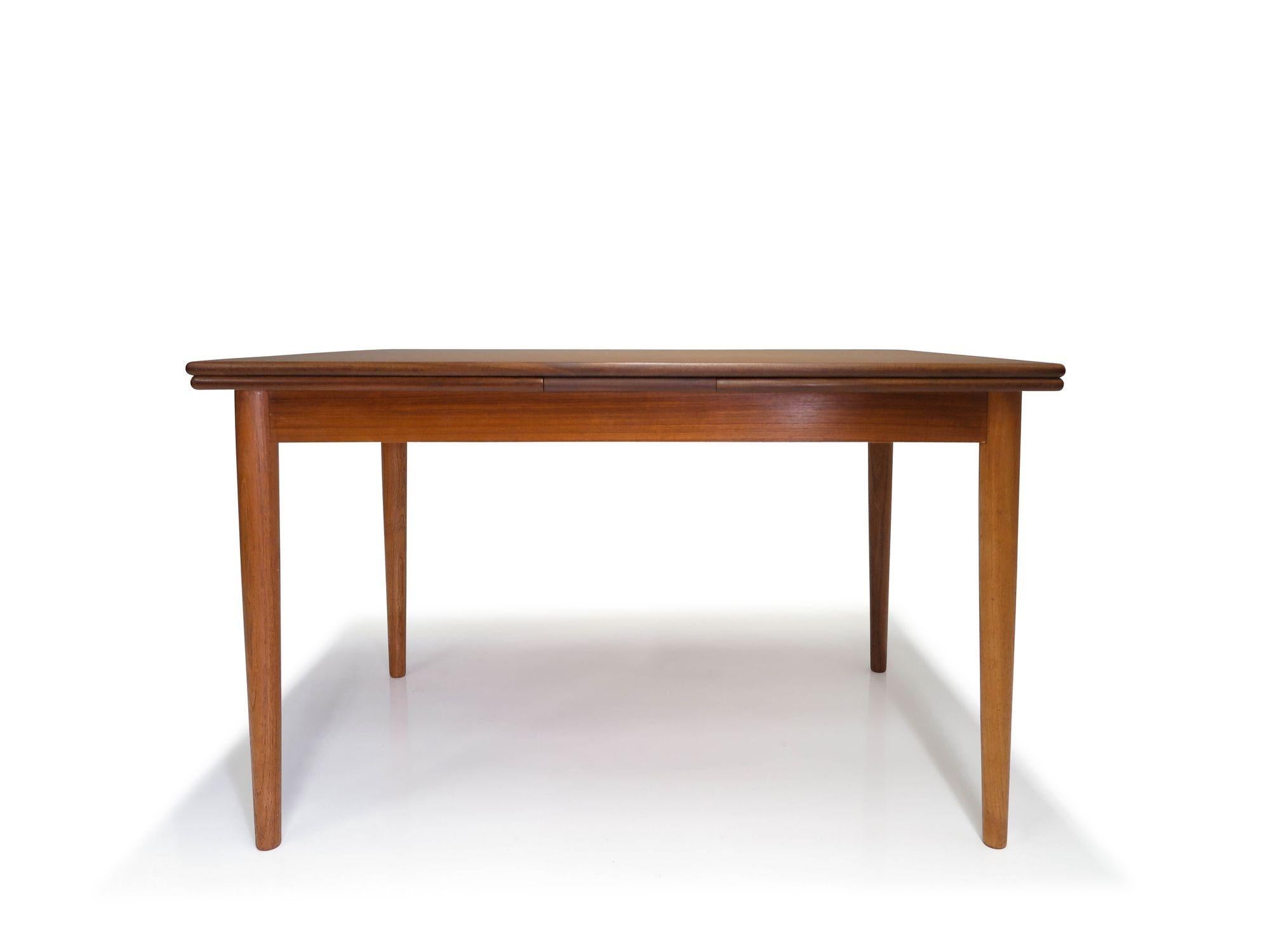 Finely crafted Danish teak dining table attributed to Arne Vodder, 1958, Denmark. The dining table is crafted of teak with solid wood edge band, and two draw-leaves on either end. The table is raised on tapered legs. The table has been
