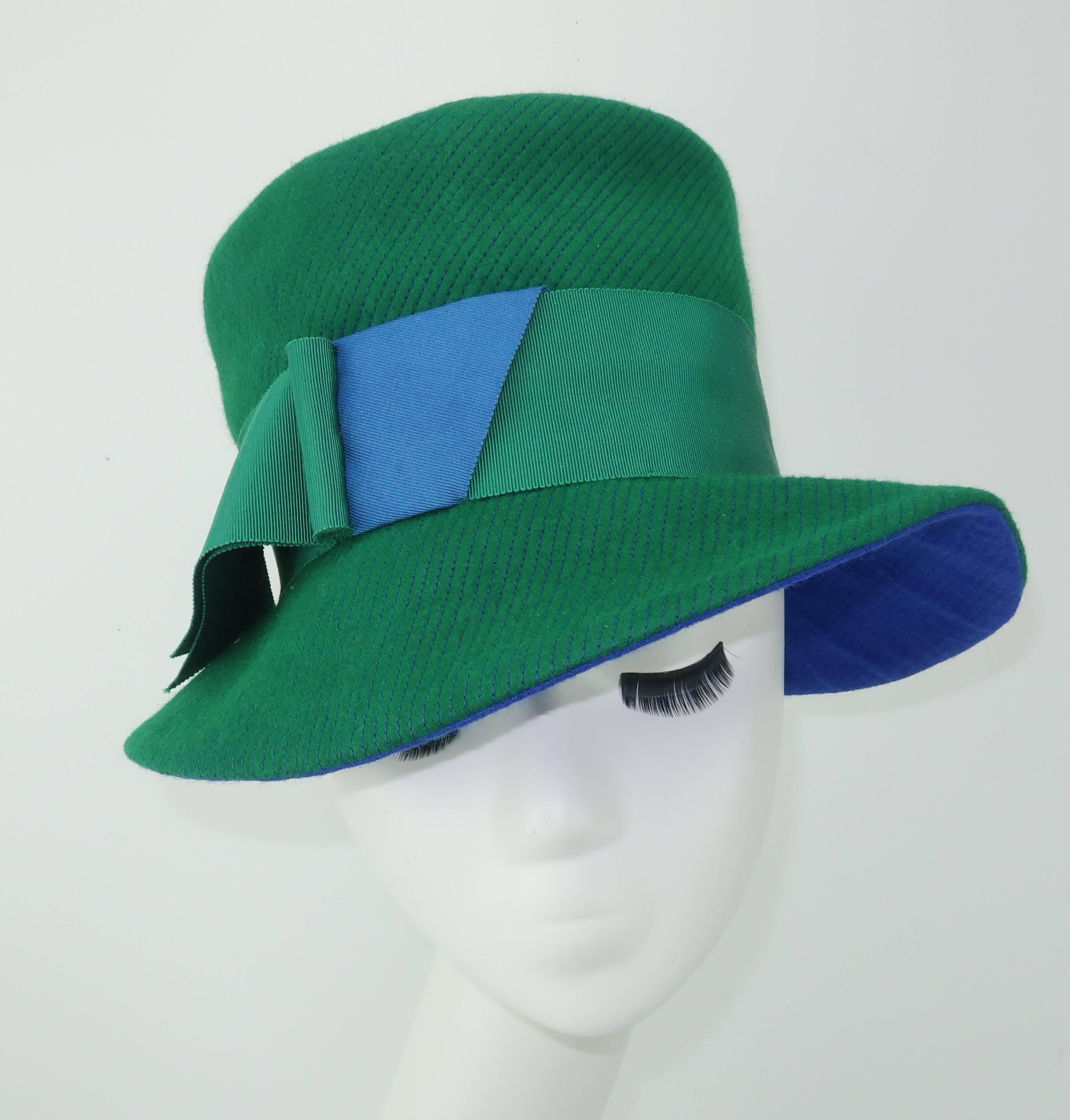 It is all in the details with this Amy of New York floppy brimmed hat.  The bright green exterior is formed with a soft wool featuring an electric blue contrast stitching which coordinates with the lining.  The brim is decorated with a two tone