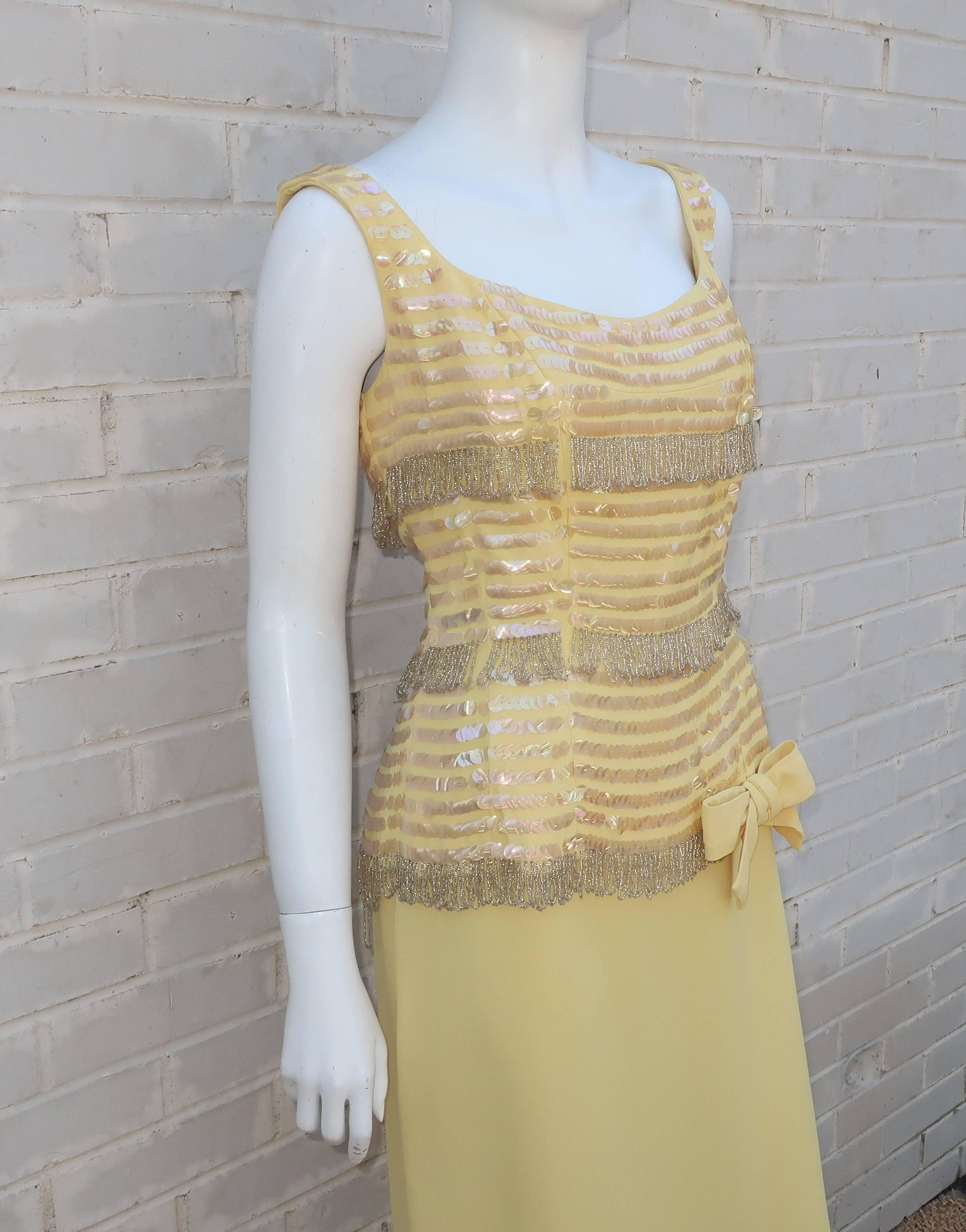 Wowza!  Walk the red carpet and shimmy all night long in this fun C. 1960 evening dress from Bernetti, a New York design firm specializing in beaded evening wear.  The strapless dress is fabricated from a buttery yellow silk crepe with a bodice