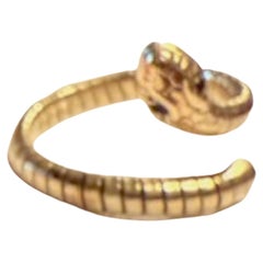 c1960 Flexible coiled snake ring with green garnet eyes will fit size 7 to 10