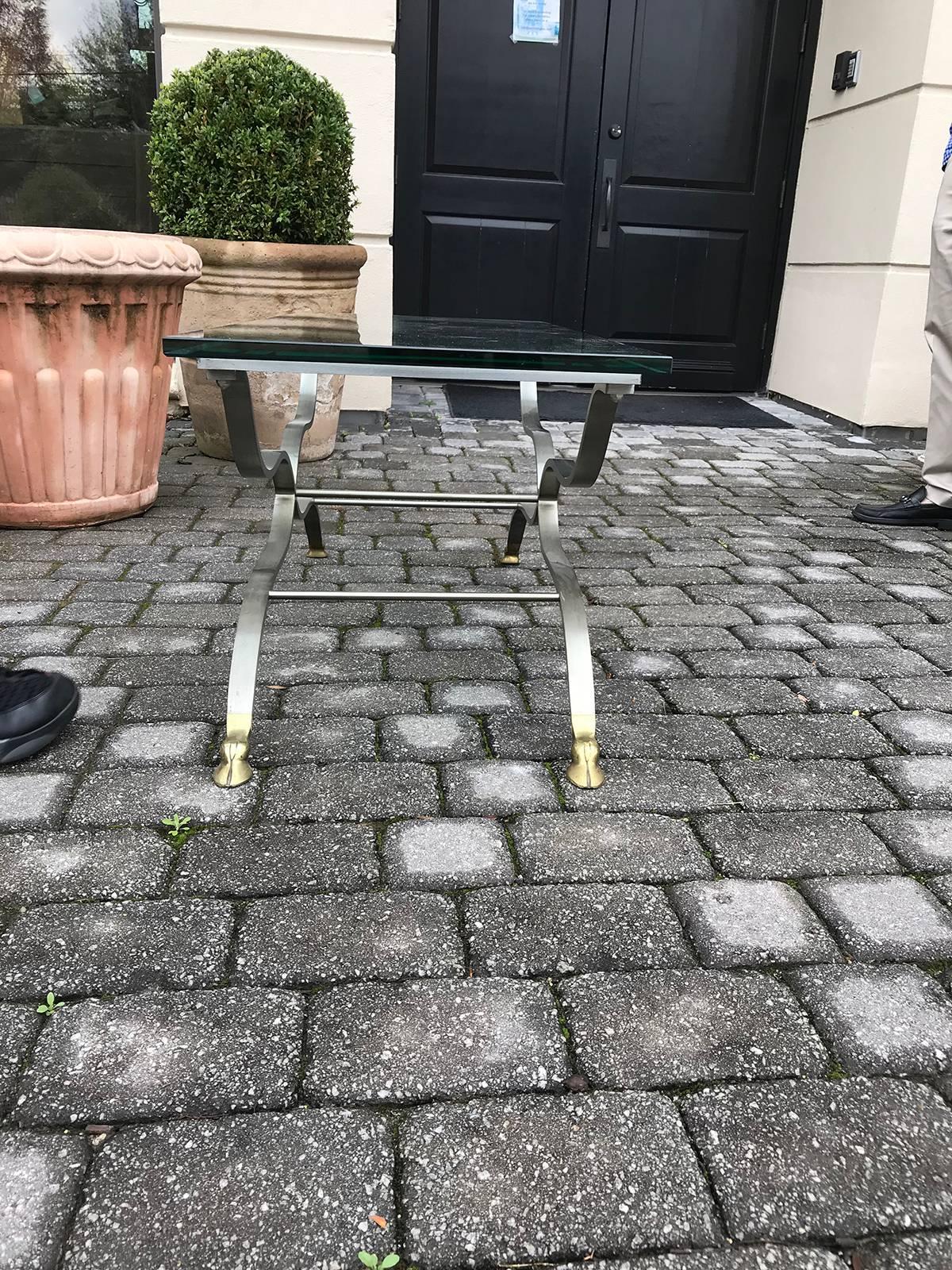 French Maison Jansen brass and steel coffee table with hoof feet, made in France, circa 1960. Does not include the glass, base only glass size was 48