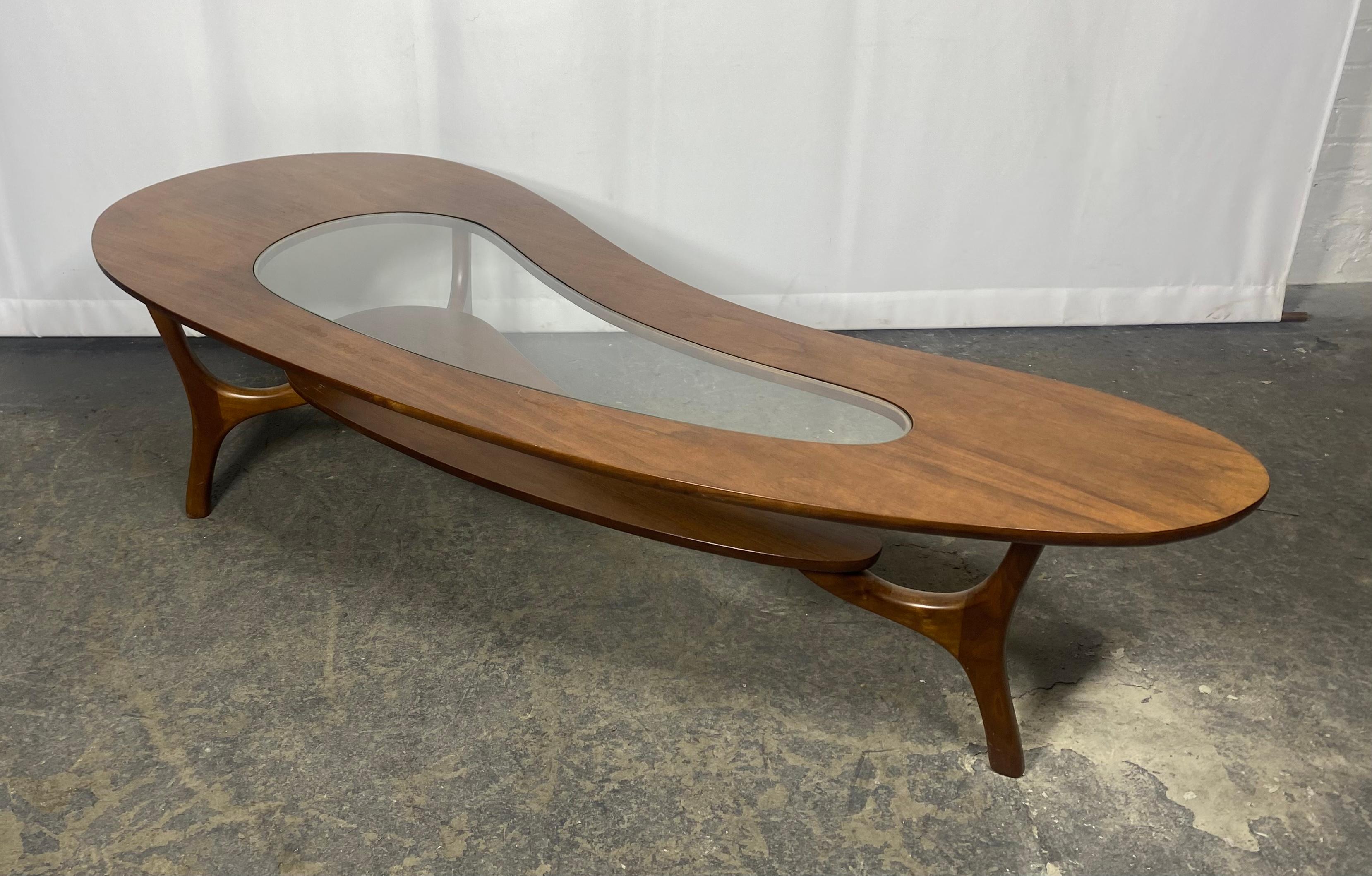 Exceptional and beautiful , Mid-Century Modern biomorphic two tier kidney shaped sculptural walnut and glass cocktail coffee table in the style of Adrian Pearsall, circa 1960’s. Rich walnut wood frames a kidney shaped inlay of glass.Great original