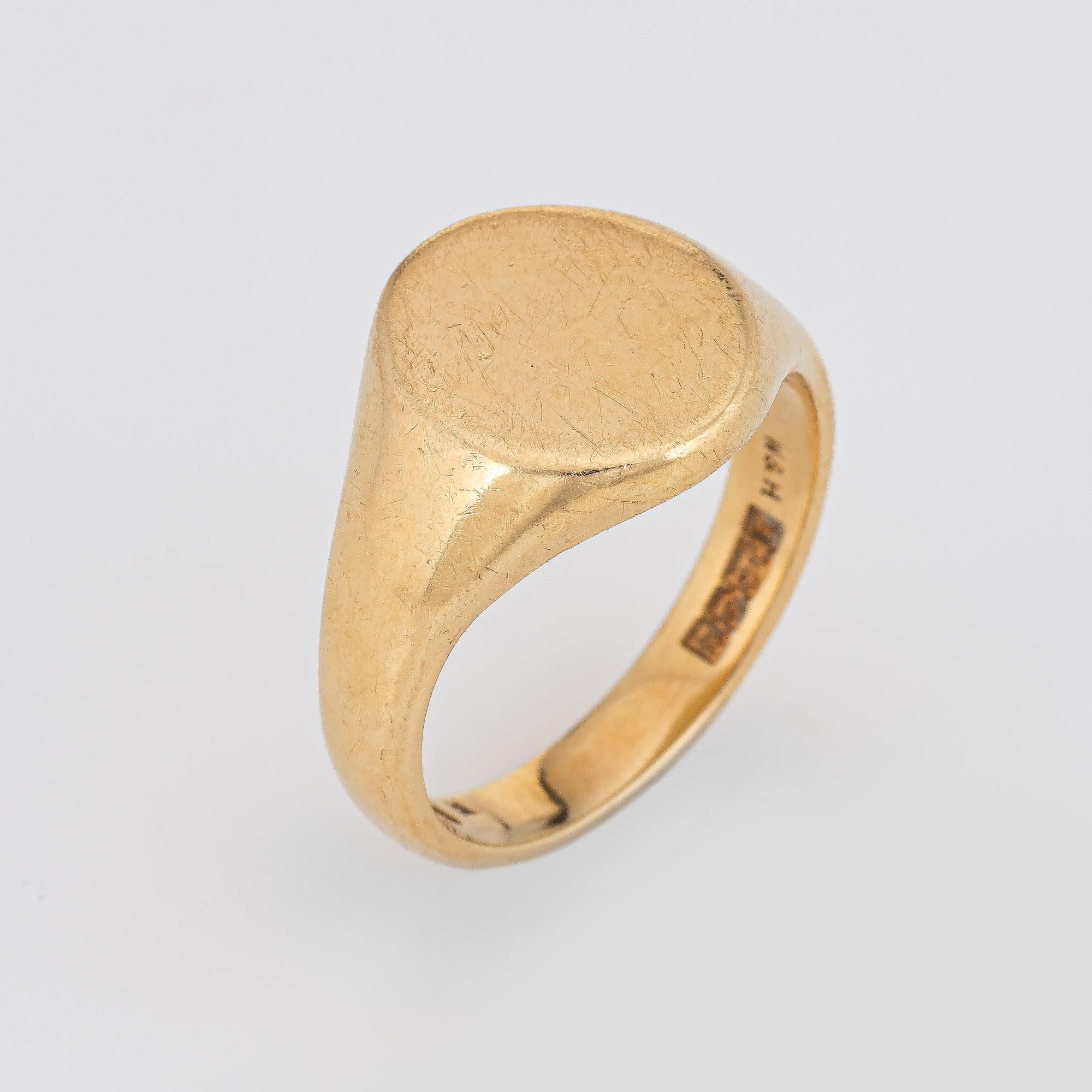 Stylish vintage signet ring (circa 1962) crafted in 18 karat yellow gold. 

The oval signet has a weighty feel (11.7 grams) and sits flat on the finger (rises 2.5mm from the finger 0.09 inches). Crafted in buttery 18k yellow gold, the signet mount