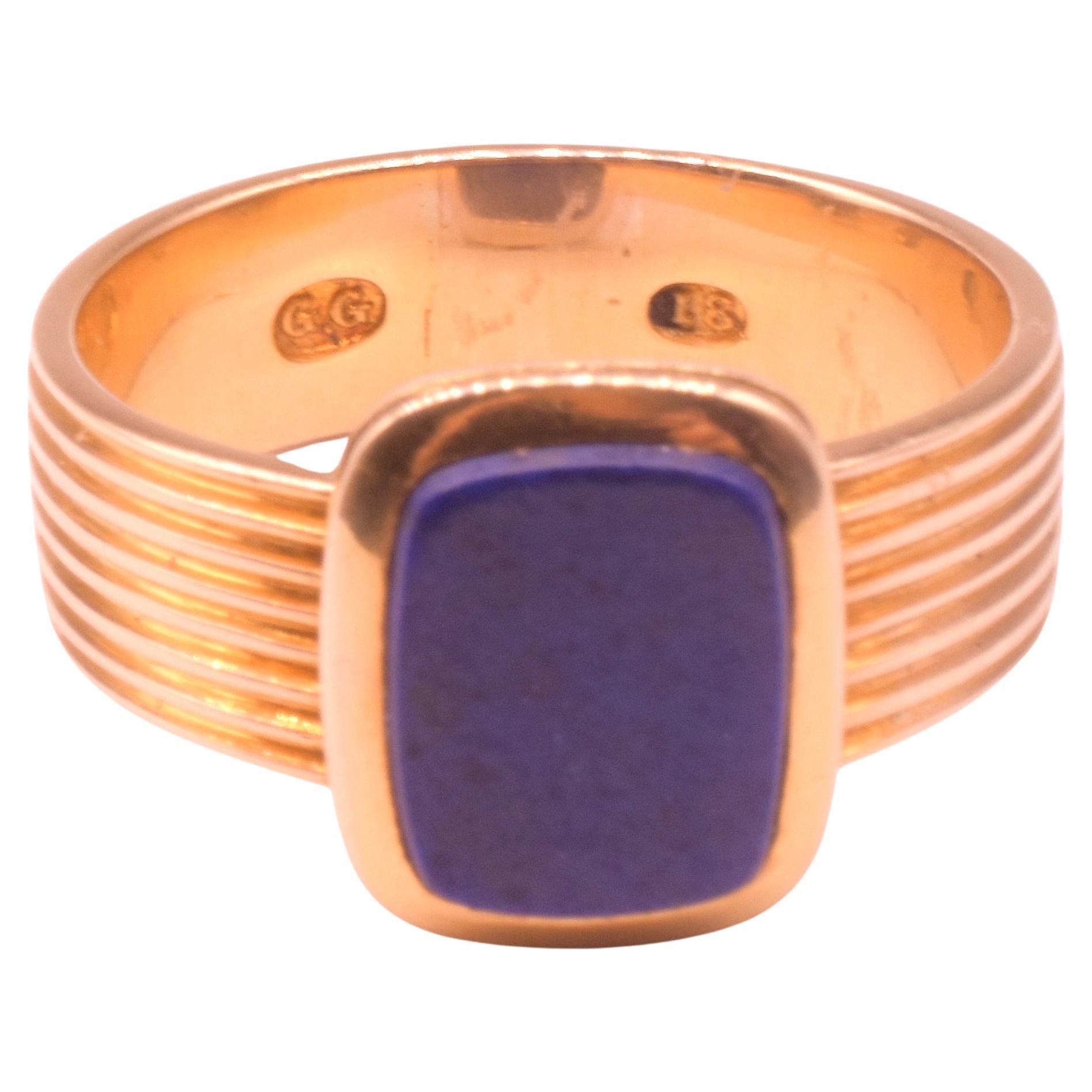 We love the classic design of our 1970's era Lapis Lazuli signet ring with its reeded gold wide band that continues all around and culminates in a pleasing rectangular shaped lapis stone with filleted corners. A single carved groove around the