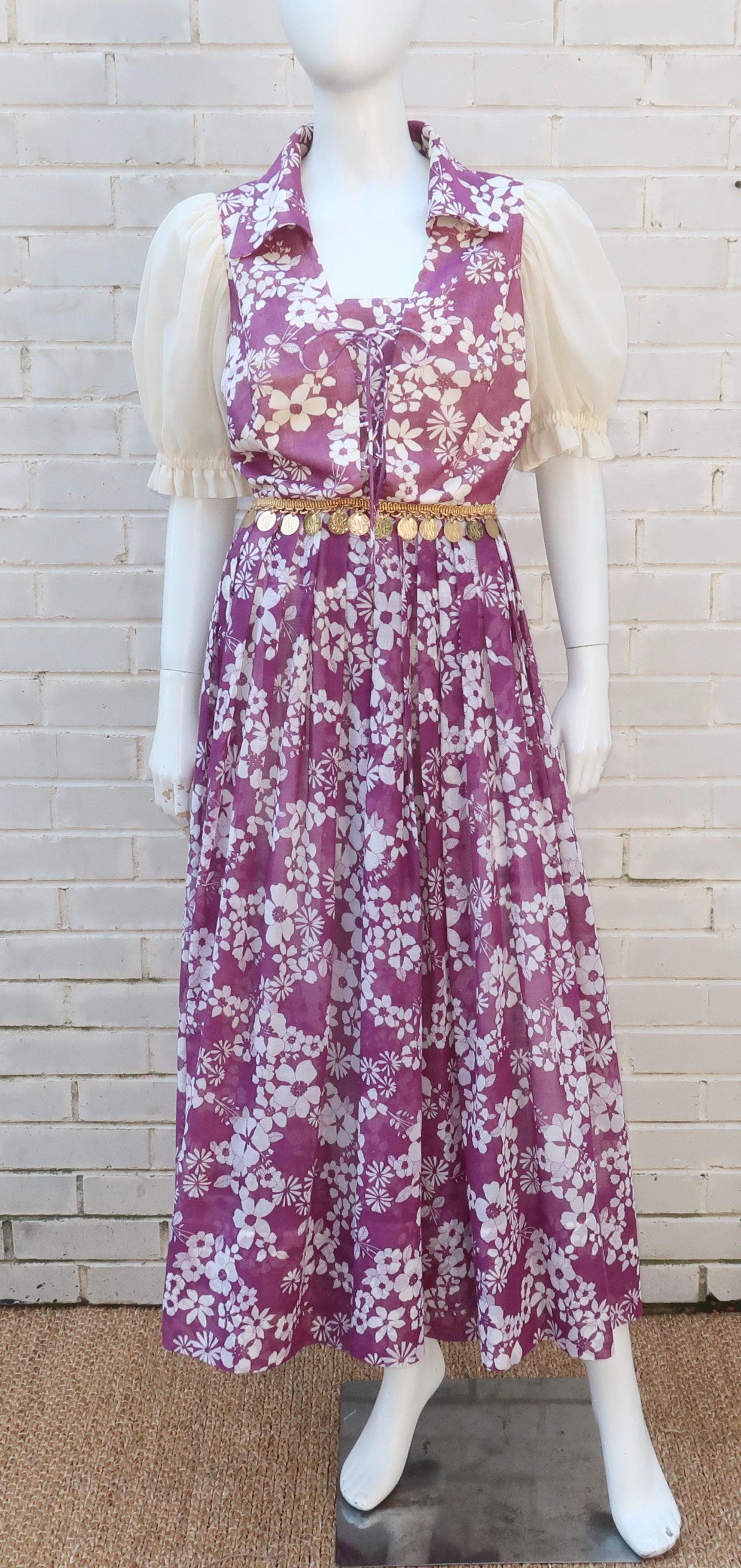 This C.1970 peasant dress design is a mix of hippie meets gypsy with an ethereal lightweight cotton blend fabric in a creme and purple floral print.  The midi length is actually a surprise split skirt providing the ease of a jumpsuit with the
