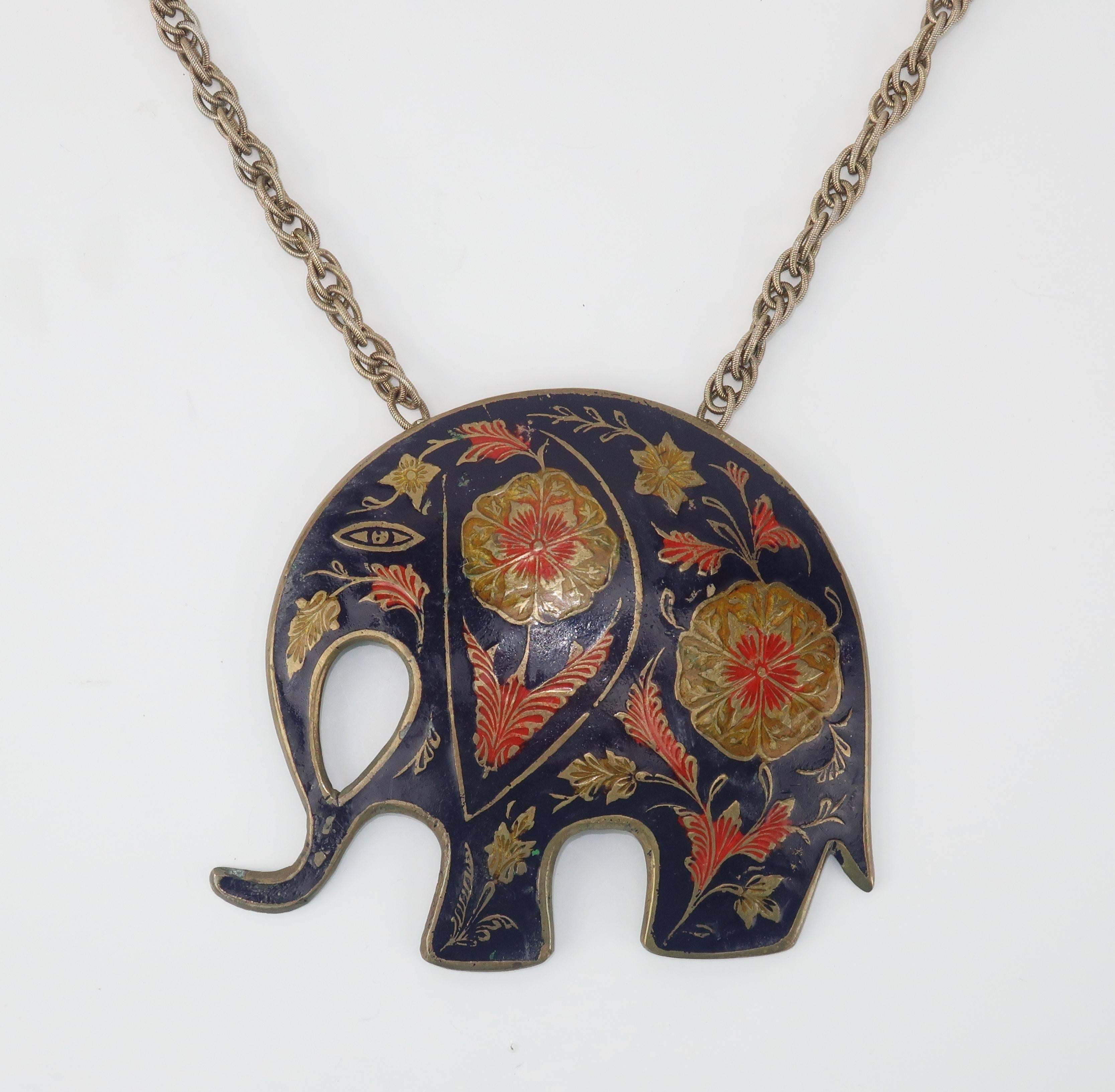 This stylized Indian brass elephant has a bohemian vibe with enamel painted decoration in shades of dark blue, red and golden yellow.  Measuring 4.25